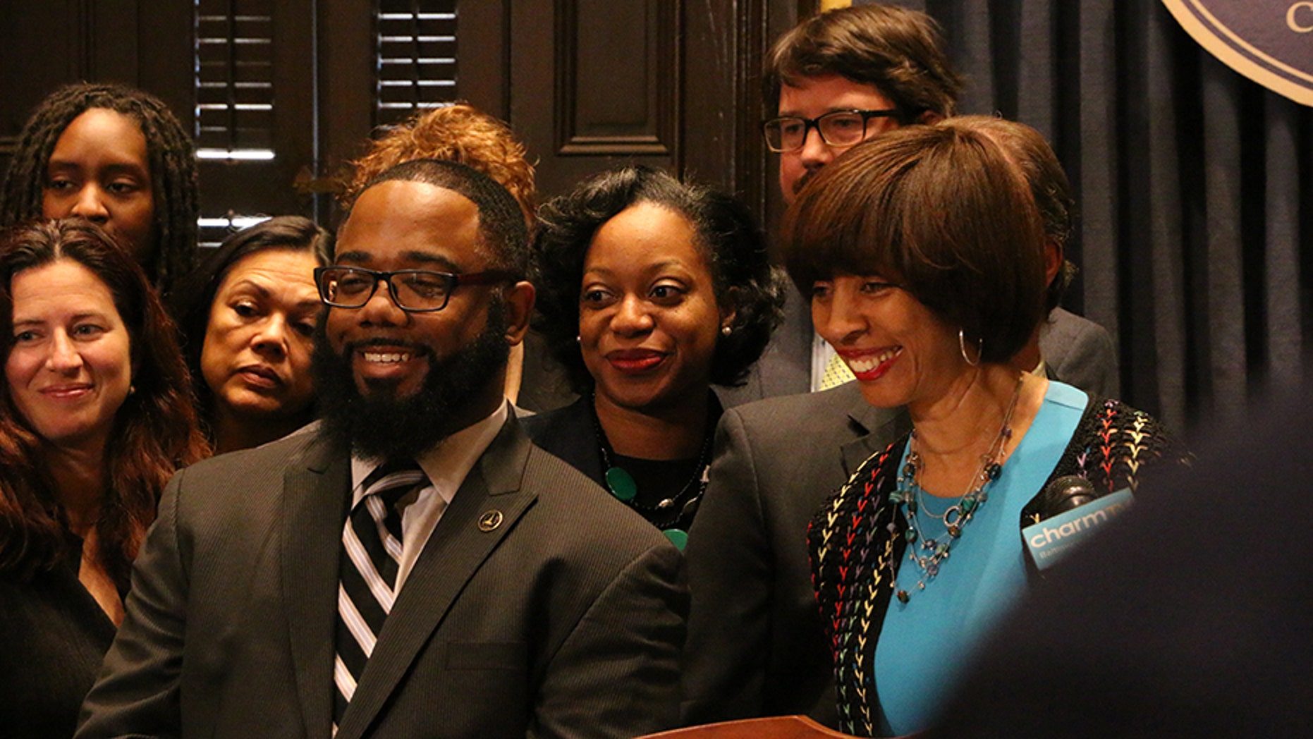 Darryl Strange, pictured with Baltimore Mayor Catherine Pugh, was a city police officer between 2006 and 2011.