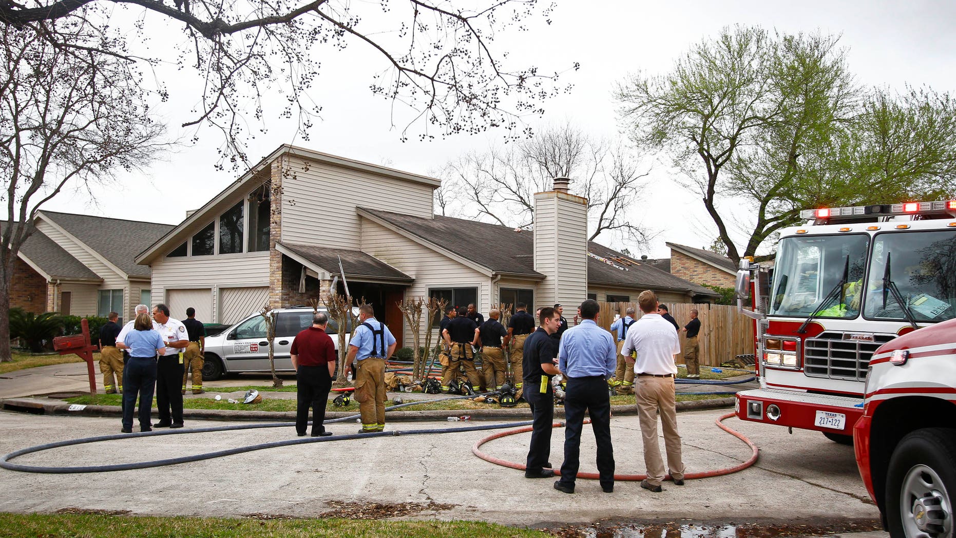 Emergency Personnel respond to the location where a fire broke out at a day care operated by Jessica Tata, 22, lkilling three children and injuring four others Thursday, Feb. 24, 2011, in Houston.