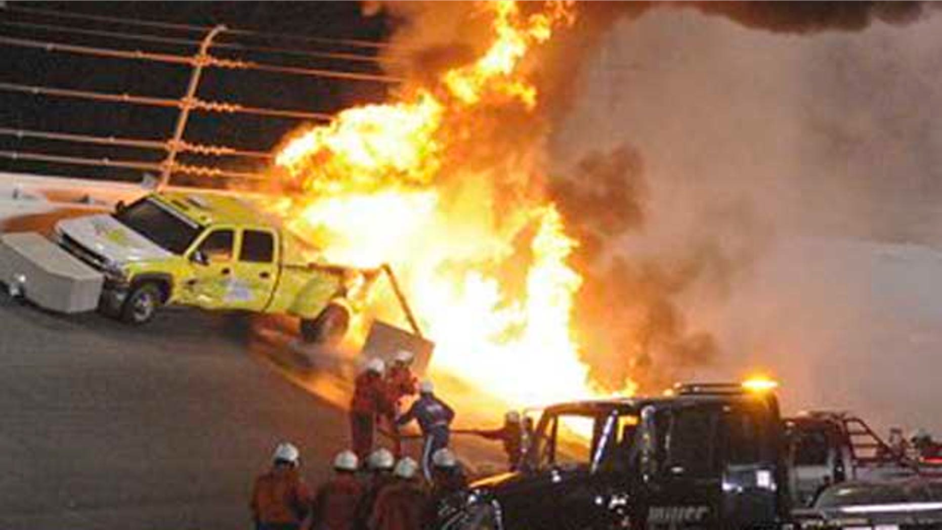 Feb. 27, 2012: Emergency workers try to extinguish a fire on a jet dryer during the NASCAR Daytona 500 auto race at Daytona International Speedway in Daytona Beach, Fla.