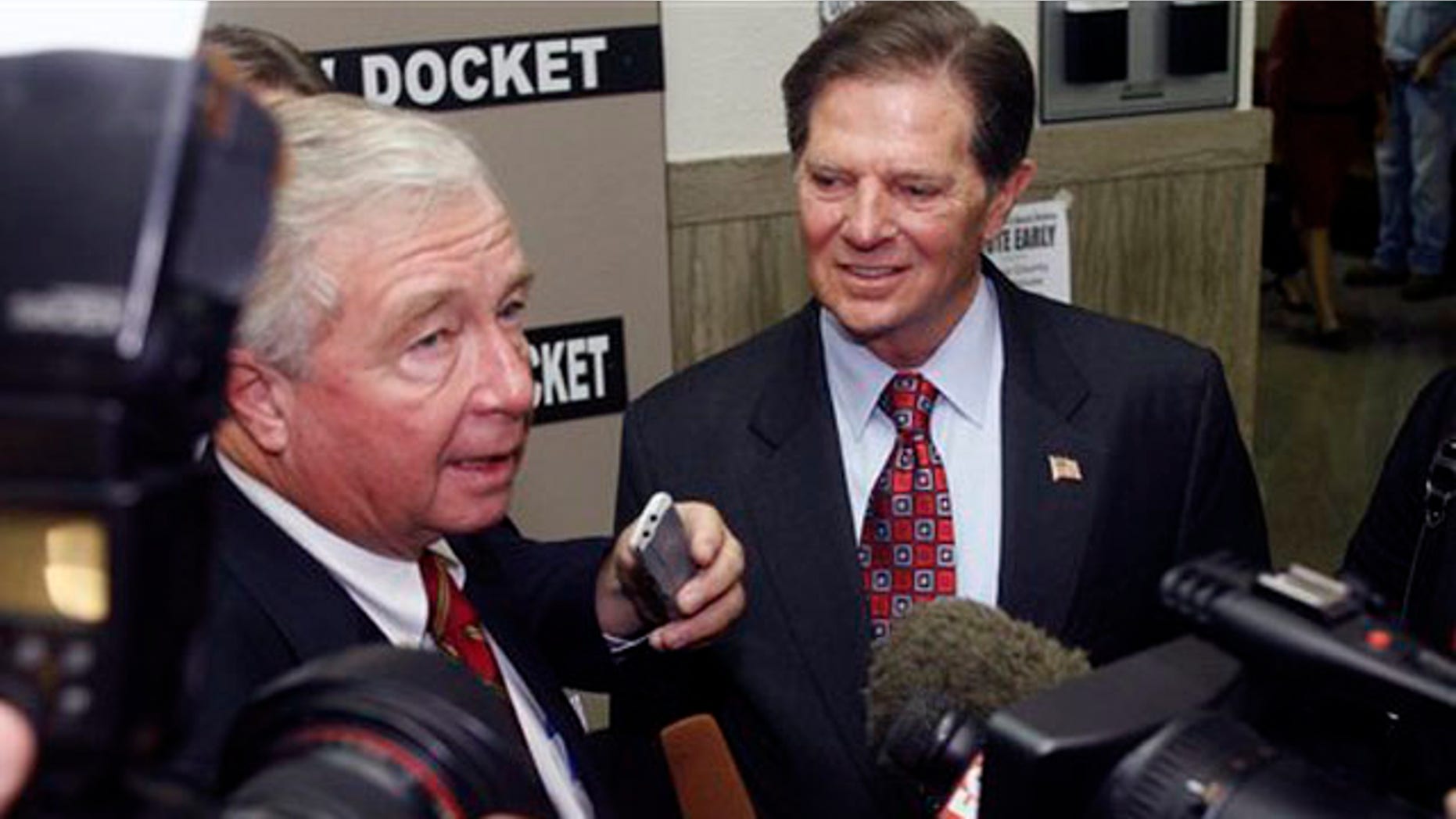 In this Oct. 26, 2010, file photo, Tom DeLay, right, answers questions from members of the media with his attorney, Dick DeGuerin, left, at the Travis County courthouse in Austin, Texas. Opening statements began Monday, Nov. 1, 2010, in the trial of the former U.S. House Majority Leader, who is accused of helping to illegally finance Texas legislative races in 2002. (AP Photo/Jack Plunkett, File)