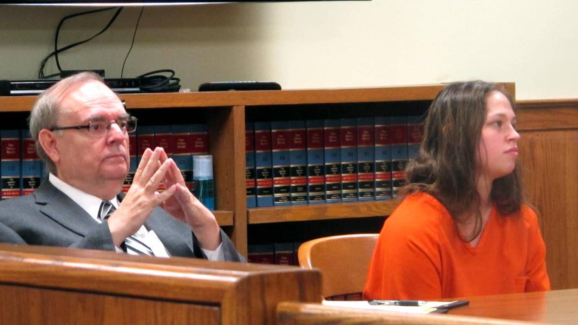 Brittany Pilkington, right, listens as a judge sets a $1 million bond in the case in which Pilkington is accused of suffocating her three sons over 13 months, with her attorney, Marc Triplett, beside her, on Thursday, Aug. 20, 2015, in Bellefontaine, Ohio. (AP Photo/Andrew Welsh-Huggins)