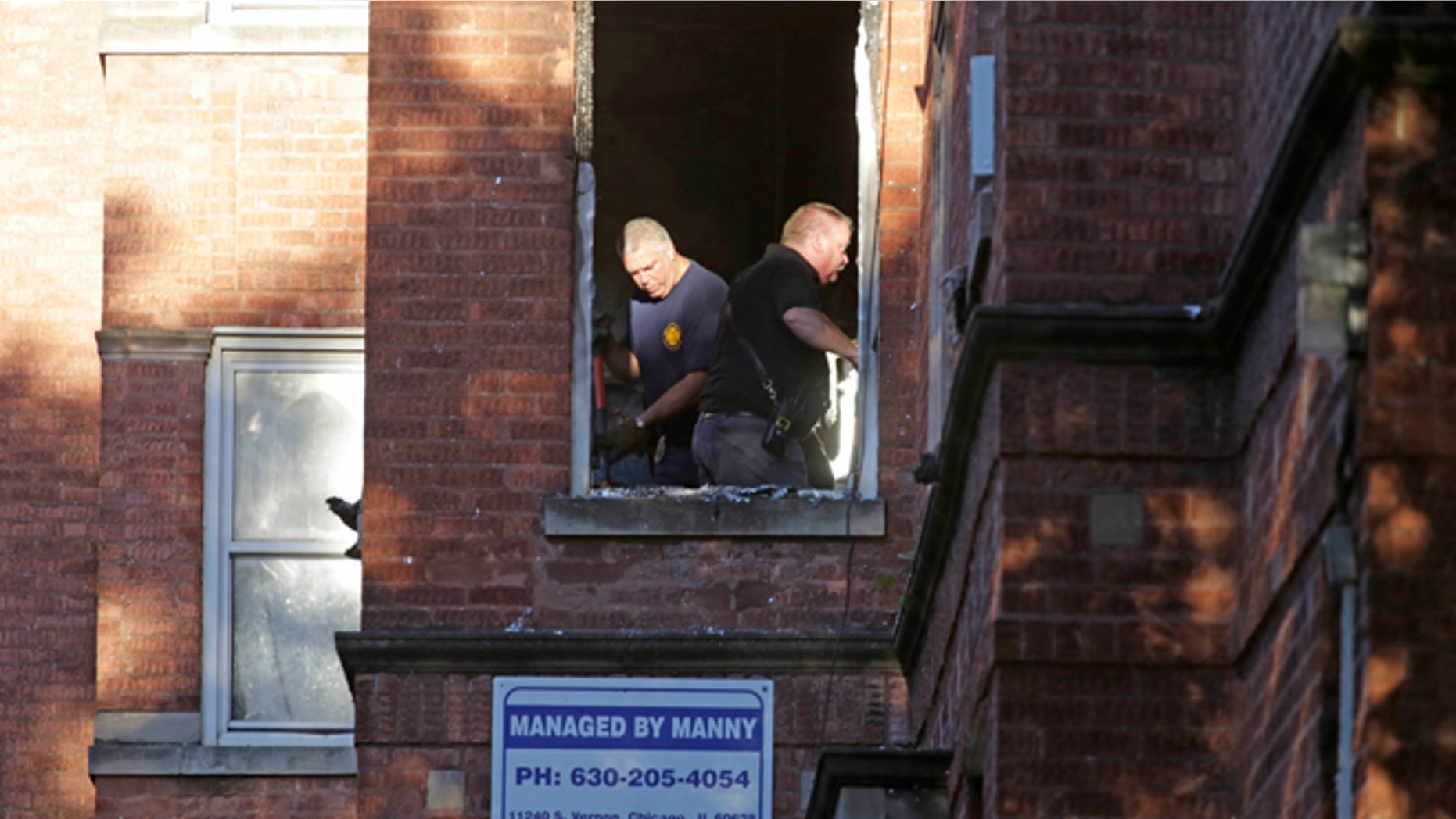 Sept. 8, 2014: Fire marshals sift through debris in an apartment building where four children died in an early morning fire in Chicago. (AP)