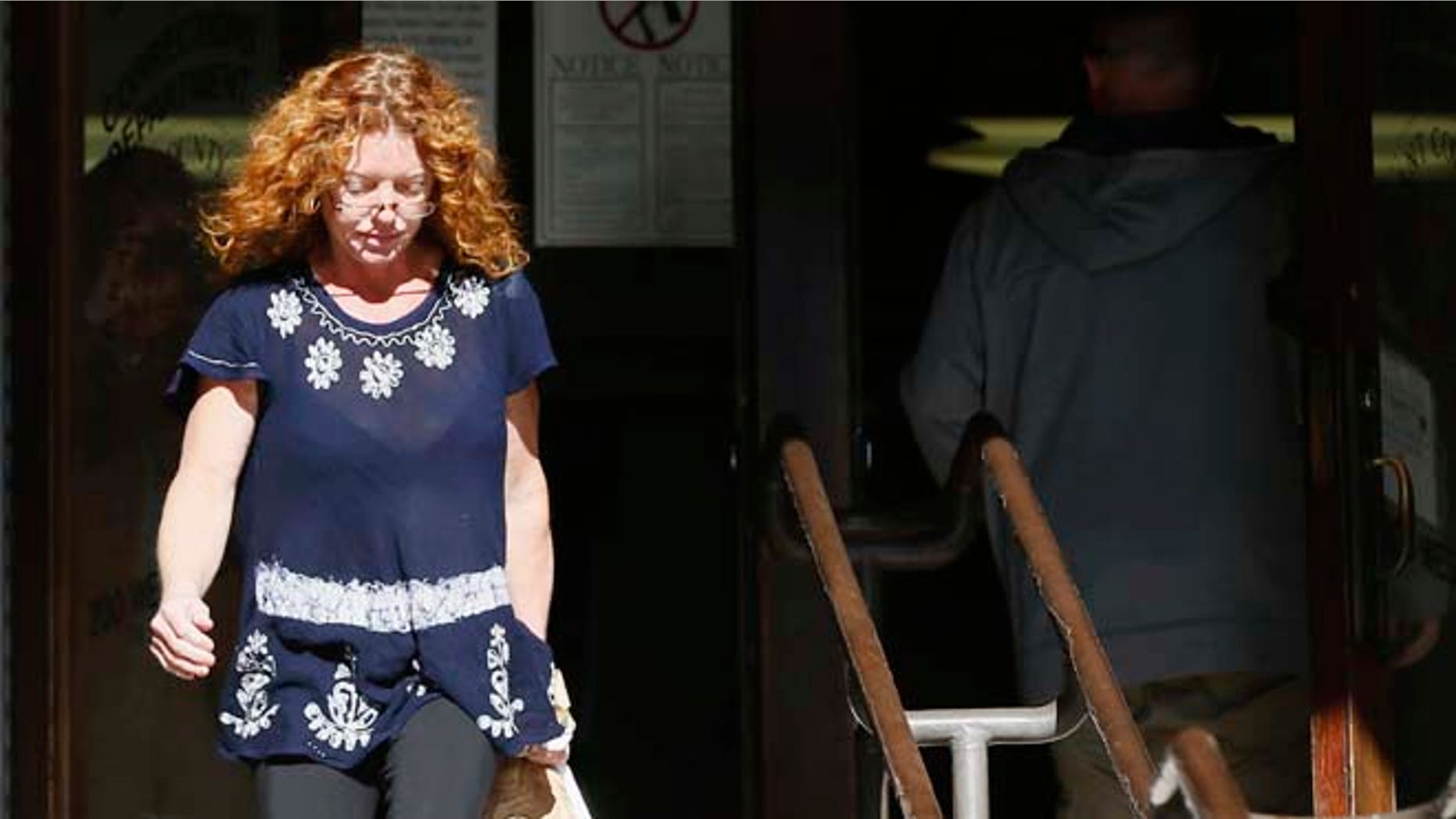 Wearing a GPS monitor on her left ankle, Tonya Couch, the mother of a Texas teen who used an "affluenza" defense in a drunken wreck, leaves Tarrant County Community Supervision and Corrections Department on Tuesday, Jan. 12, 2016, in Fort Worth, Texas. A judge decreased Couch's bond Monday from $1 million to $75,000. Couch is charged with hindering the apprehension of a felon after she and her son, Ethan Couch, were caught in a Mexican resort city. (AP Photo/Brandon Wade)