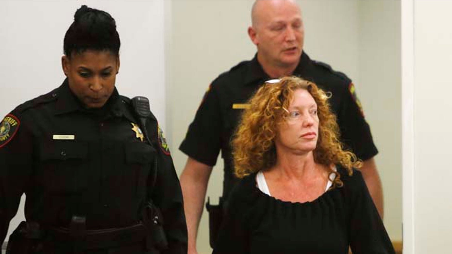 Deputies escort Tonya Couch, front right, to the defense table before her bond reduction hearing Monday, Jan 11, 2016, in court in Fort Worth, Texas. Couch, the mother of a Texas teenager who used an "affluenza" defense for a deadly wreck, could soon leave jail after a judge on Monday sharply reduced her bond. (David Kent/Star-Telegram via AP, Pool)