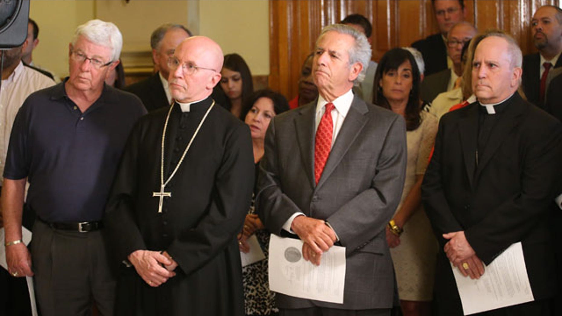 May 22, 2013: Religious leaders from Colorado, from left, Dr. Jim Ryan, Colorado Council of Churches, Dean Peter Eaton, St. John's Cathedral, Rabbi Steven Foster and Catholic Archbishop Samuel J. Aquila listen as Colorado Gov. John Hickenlooper announces at a news conference at the Capitol in Denver.