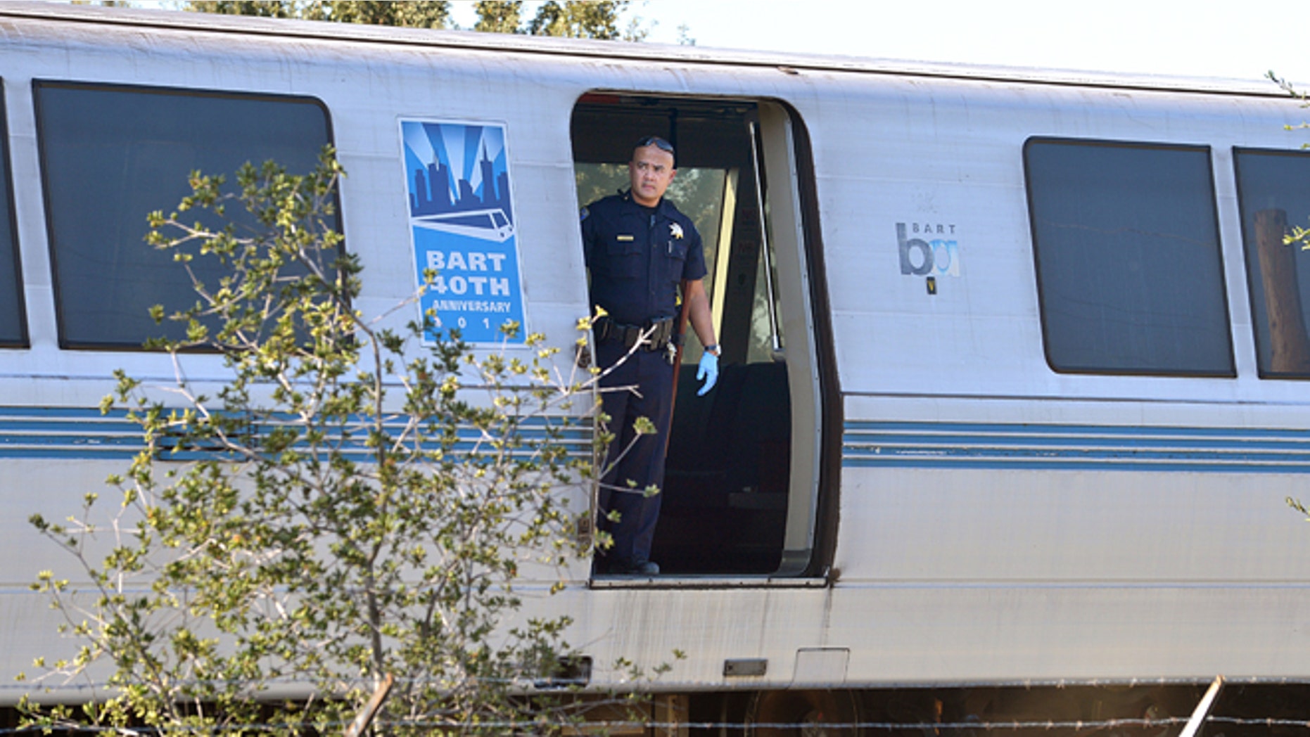 Oct. 19, 2013: A BART police officer looks out of a BART car that struck and killed two people along Jones Road in Walnut Creek, Calif.