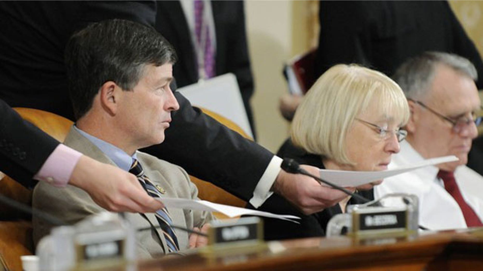 November 1, 2011: Aides deliver papers to co-chairmen Rep. Jeb Hensarling (R-TX) (L) and Senator Patty Murray (D-WA) during a hearing of the U.S. Joint Select Committee on Deficit Reduction on Capitol Hill in Washington.