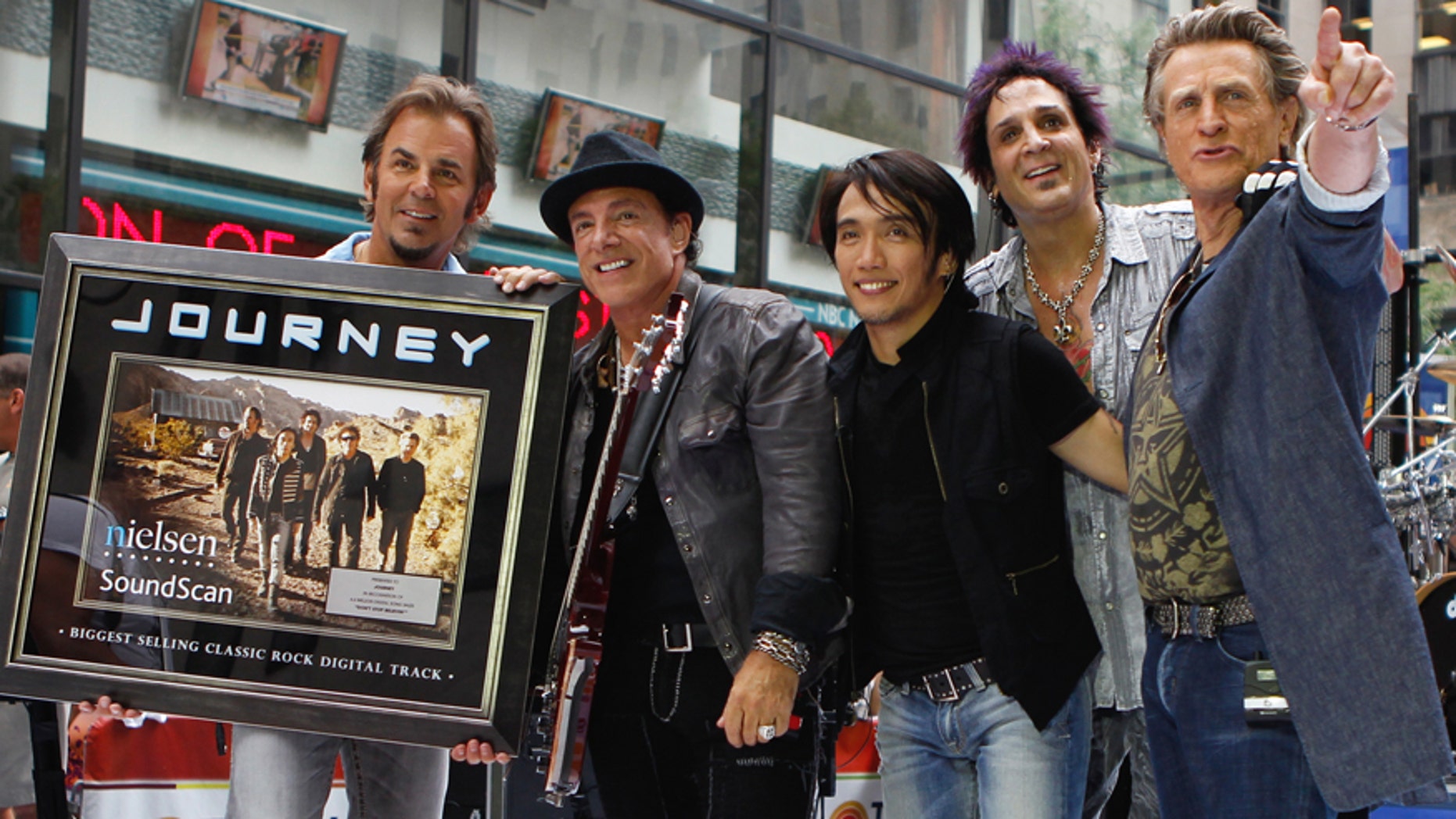 Journey band members (L-R) Jonathan Cain, Neal Schon, Arnel Pineda, Deen Castronovo, and Ross Valory pose together after performing on NBC's Today Show in New York July 29, 2011. REUTERS