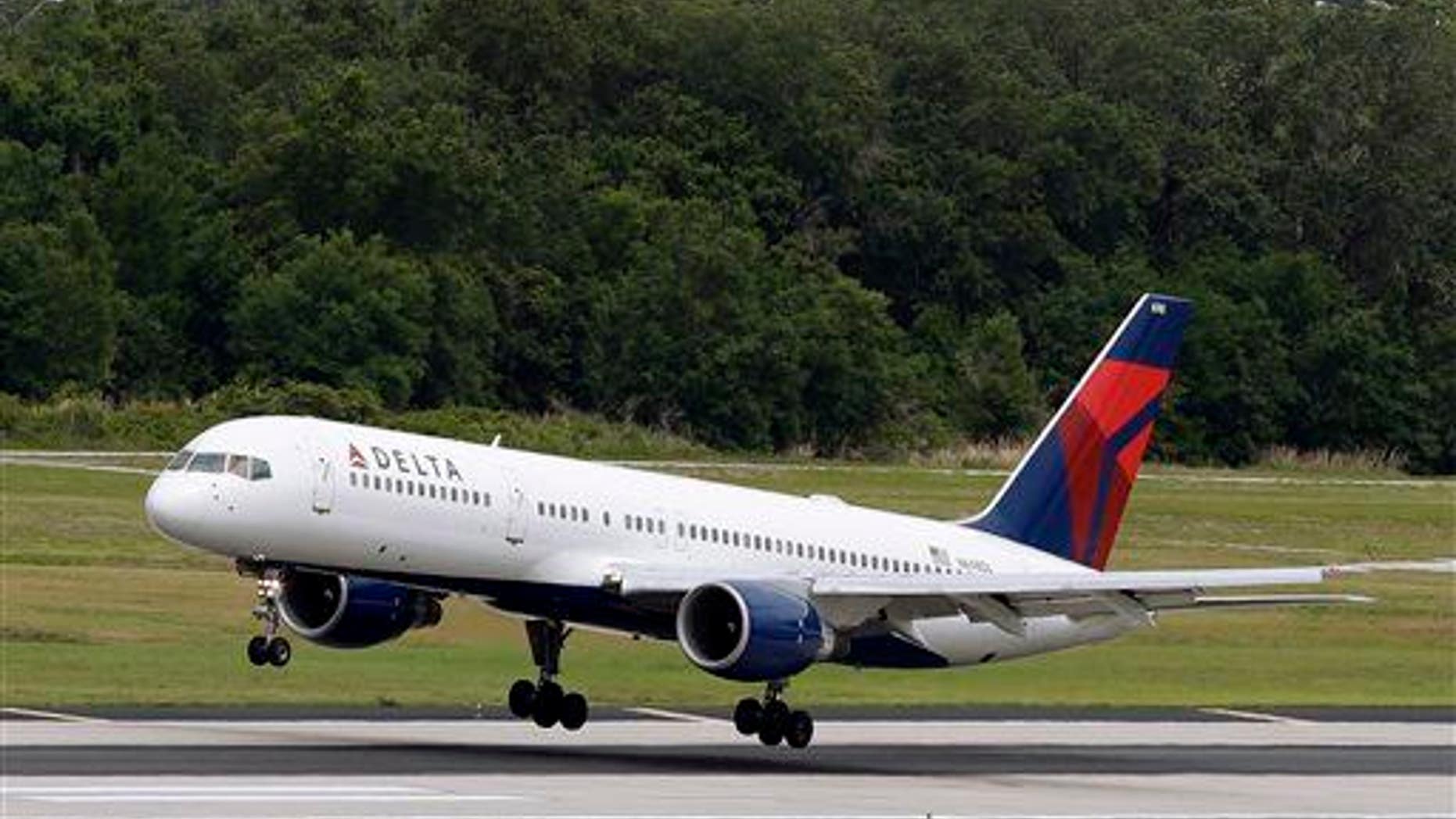 In this Thursday, May 15, 2014, file photo, a Delta Air Lines Boeing 757-232 lands at the Tampa International Airport in Tampa, Fla.