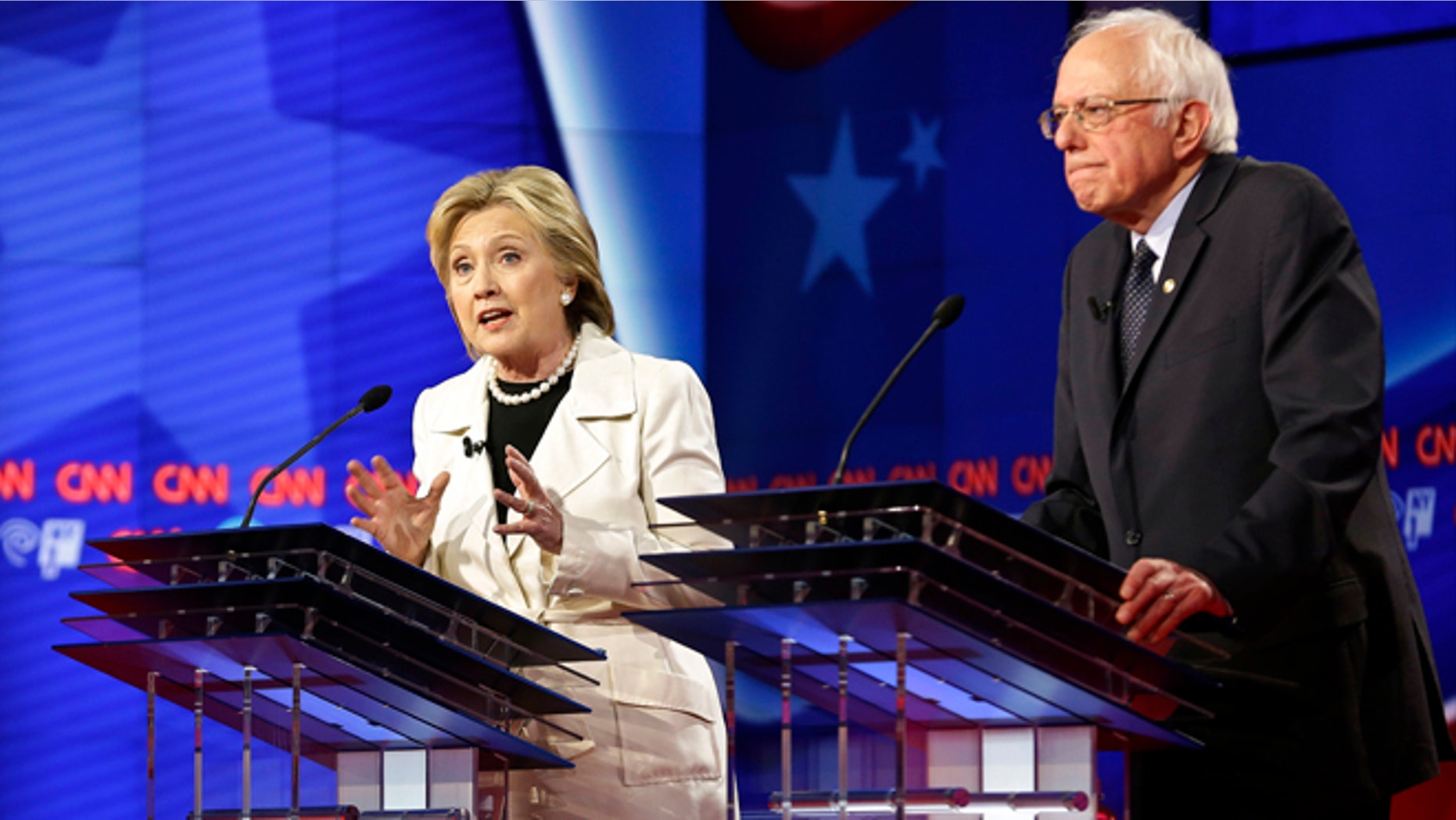 Democratic presidential candidates Sen. Bernie Sanders, I-Vt., right, listens as Hillary Clinton speaks during the CNN Democratic Presidential Primary Debate at the Brooklyn Navy Yard Thursday, April 14, 2016, New York. (AP Photo/Seth Wenig)