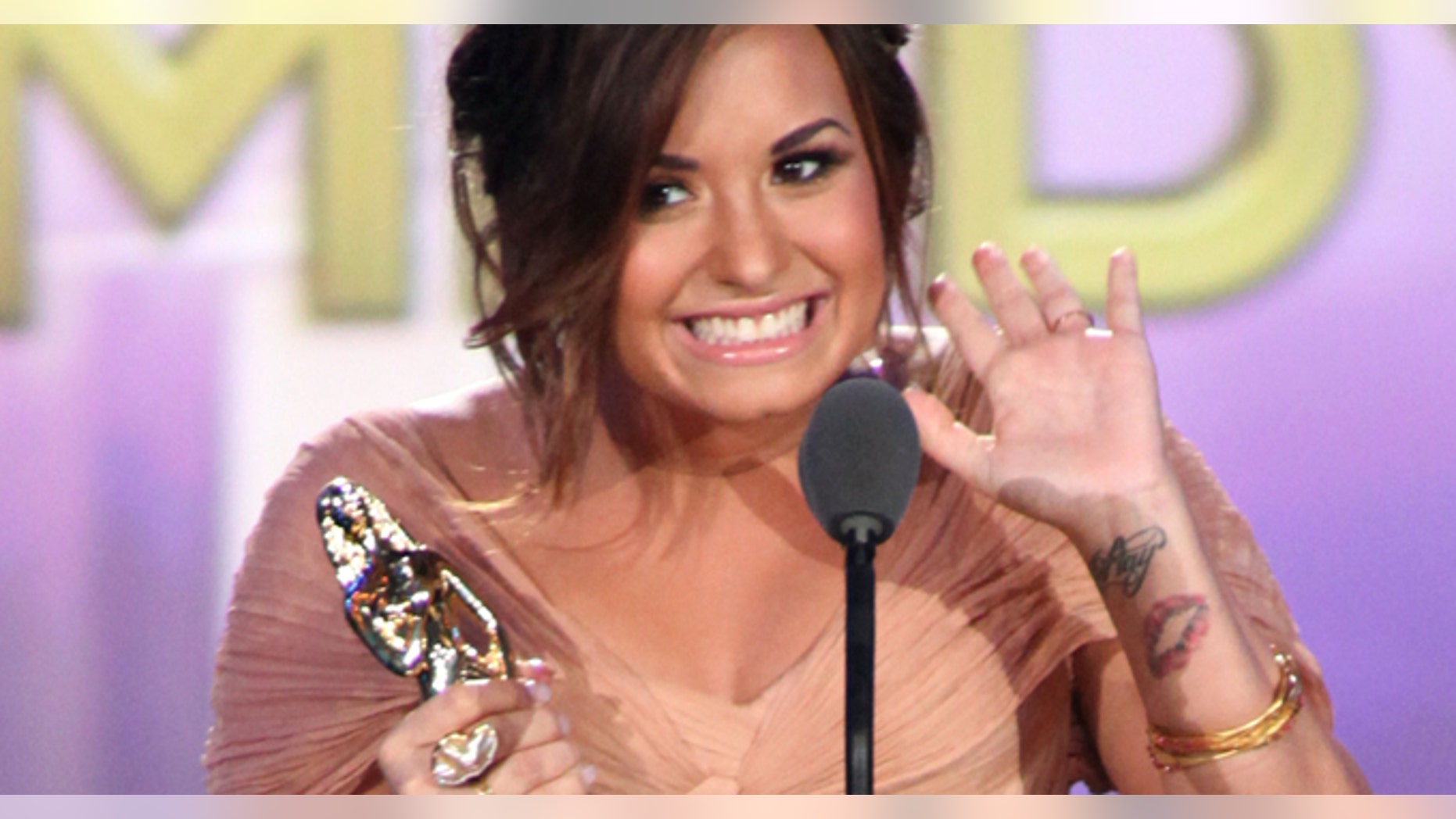 SANTA MONICA, CA - SEPTEMBER 10: Actress Demi Lovato accepts the award for Favorite TV Actress - Leading Role in a Comedy during the 2011 NCLR ALMA Awards pre-show held at Santa Monica Civic Auditorium on September 10, 2011 in Santa Monica, California. (Photo by Jesse Grant/Getty Images for NCLR)