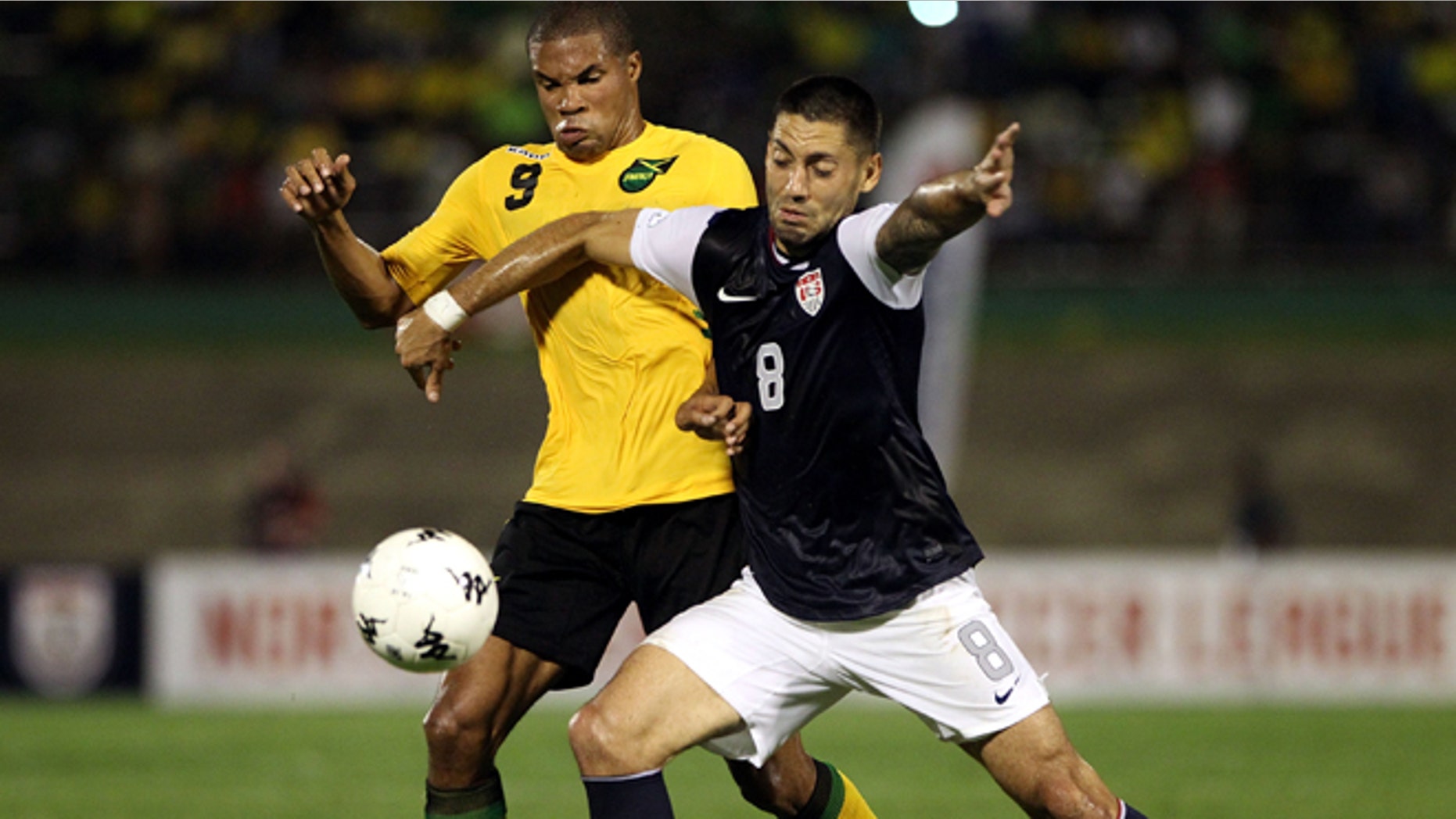 KINGSTON, JAMAICA - SEPTEMBER 07: Clint Dempsey #8 of the United States battles for the ball with Ryan Johnson #9 of Jamaica during the United States and Jamaica World Cup Qualifier at National Stadium on September 7, 2012 in Kingston, Jamaica. (Photo by Marc Serota/Getty Images)