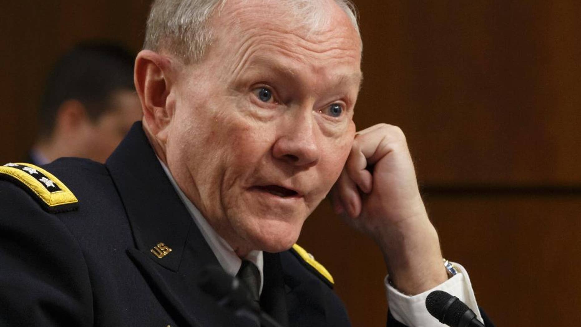 In this Tuesday, Sept. 16, 2014 photo, Army Gen. Martin Dempsey, chairman of the Joint Chiefs of Staff, appeared before the Senate Armed Services Committee, on Capitol Hill in Washington. Speaking to a small group of reporters after meeting with his French counterpart on Thursday, Sept. 18, 2014 in Paris, Dempsey said it will take three or four months to begin the $500 million training program, which the House approved on Wednesday and sent to the Senate, where members of both parties predicted easy passage. (AP Photo/J. Scott Applewhite)