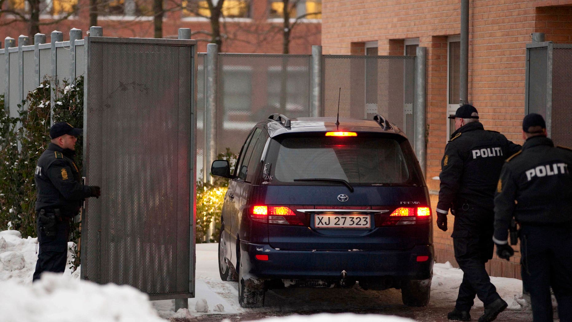 Dec. 30: Danish police officers stand guard as a suspect arrested on suspicion of planning a shooting attack on the office of a newspaper that published cartoons of the Prophet Muhammad arrives at a court in Glostup, south of Copenhagen.