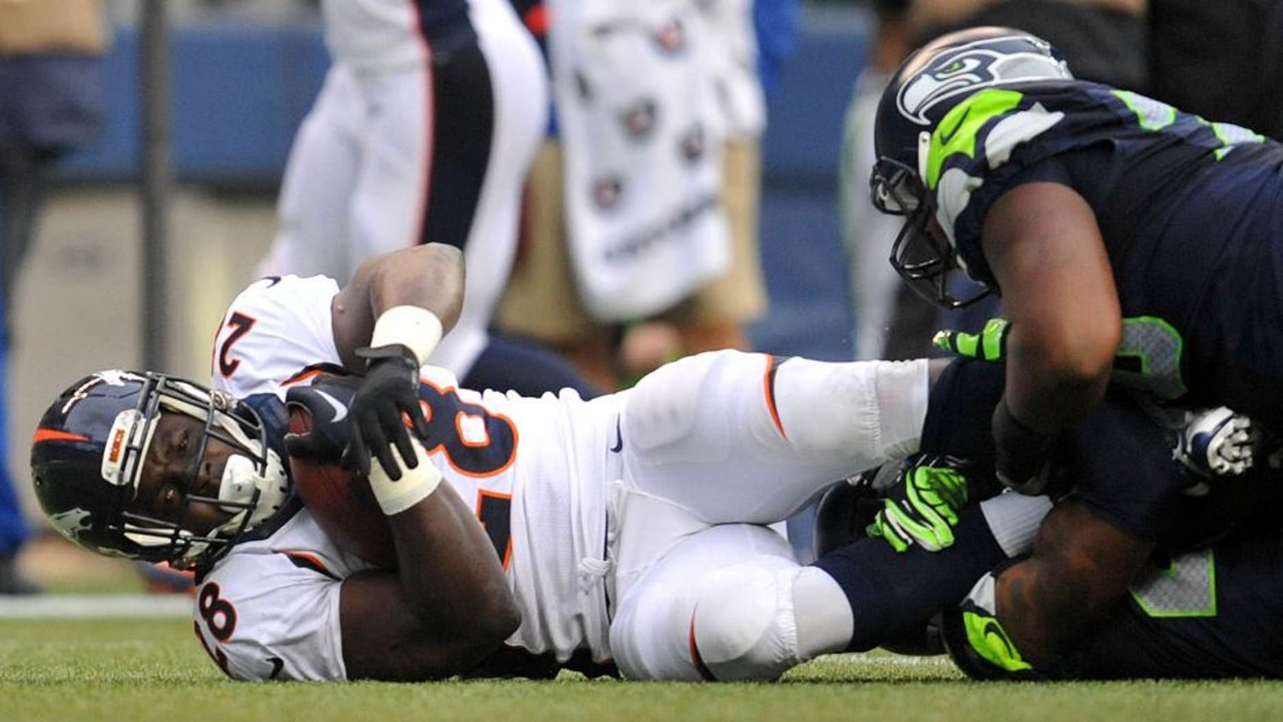 August 14, 2015; Seattle, WA, USA; Denver Broncos running back Montee Ball (28) is brought down by the Seattle Seahawks defense during the first half in a preseason NFL football game at CenturyLink Field. Mandatory Credit: Gary A. Vasquez-USA TODAY Sports