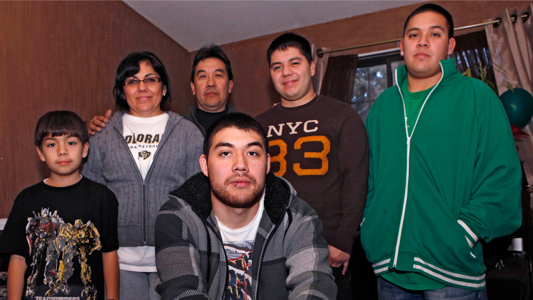Jesus Gerardo Noriega, front, poses with his parents and brothers at the family home in Aurora, Colo. Jesus, 21, faced deportation last year after he was arrested for driving with no license plate light.