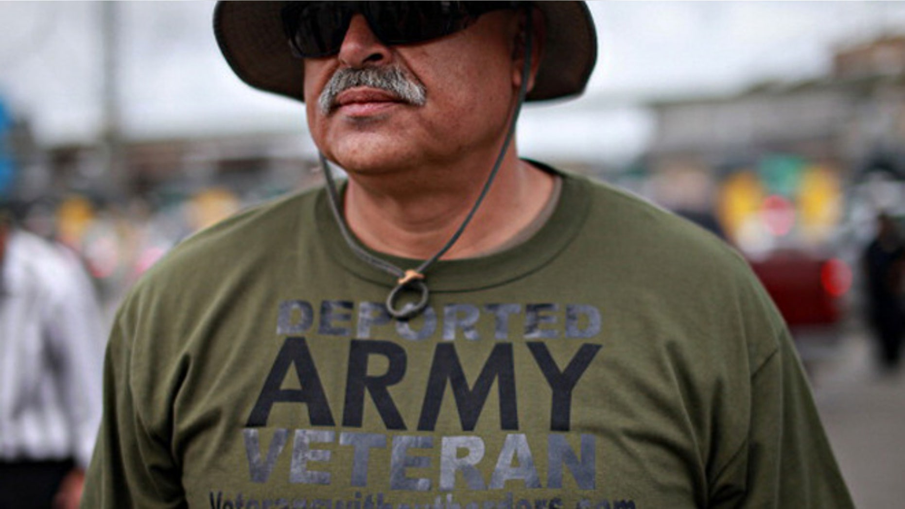 TIJUANA, MEXICO - MARCH 27: U.S. Army veteran Hector Lopez participates in a protest by deported military personel at the U.S.- Mexico border March 27, 2014 in Tijuana, Mexico. Several veterans organizations, including Veterans Without Borders, Banished Veterans and Coalicion Humanitaria Promigrante (CHIP) gathered for the demonstration to promote a petition to Congress and the Obama Administration, which requires 100,000 signatures in 30 days to gain an audience, demanding that deported military veterans be brought back to the United States. (Photo by Sandy Huffaker/Getty Images)