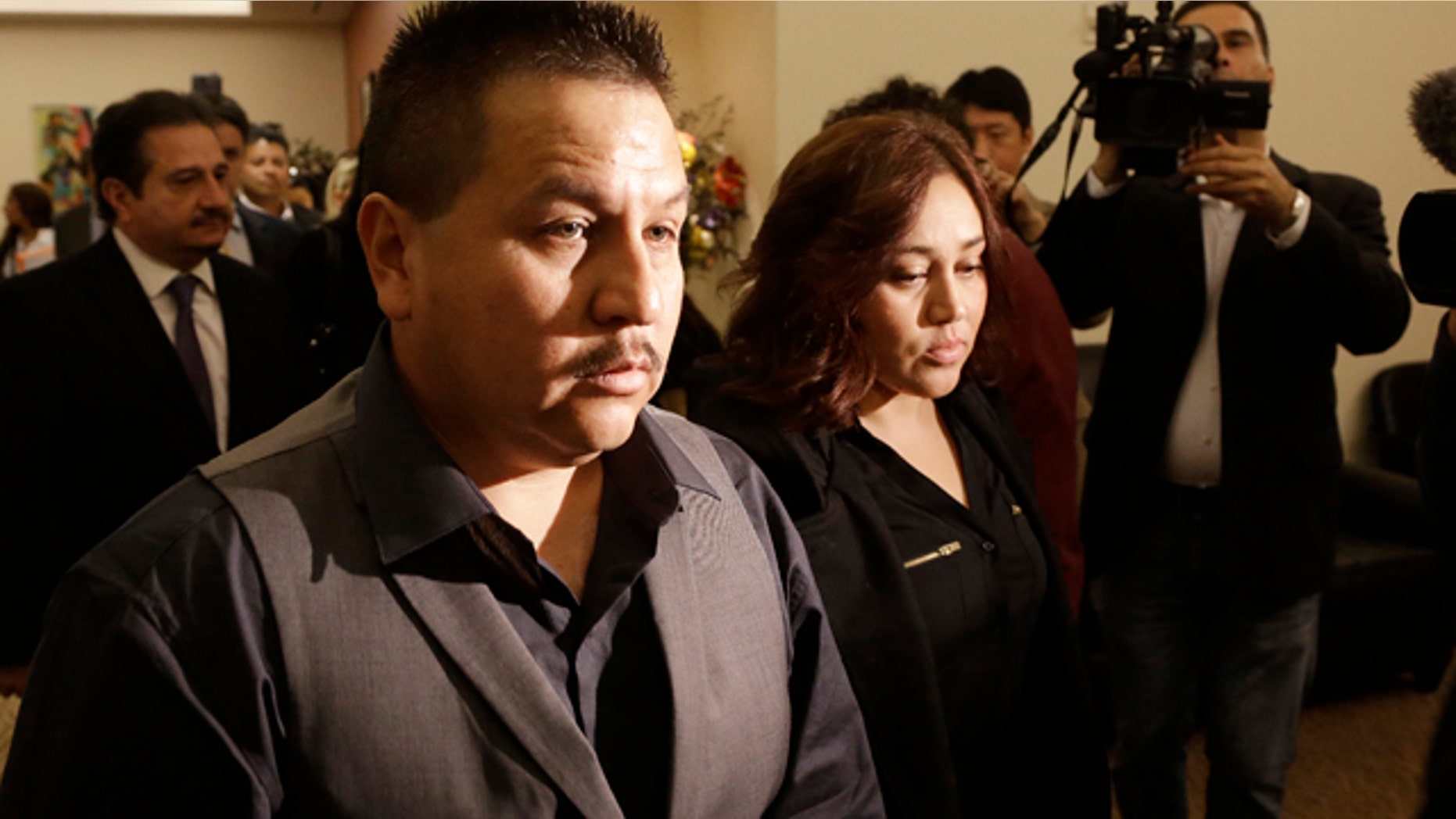 File - This Nov. 4, 2013 file photo shows Rodrigo Lopez, left, and Sujay Cruz, parents of Andy Lopez, as they walk to a news conference in San Francisco. (AP Photo/Jeff Chiu, file)