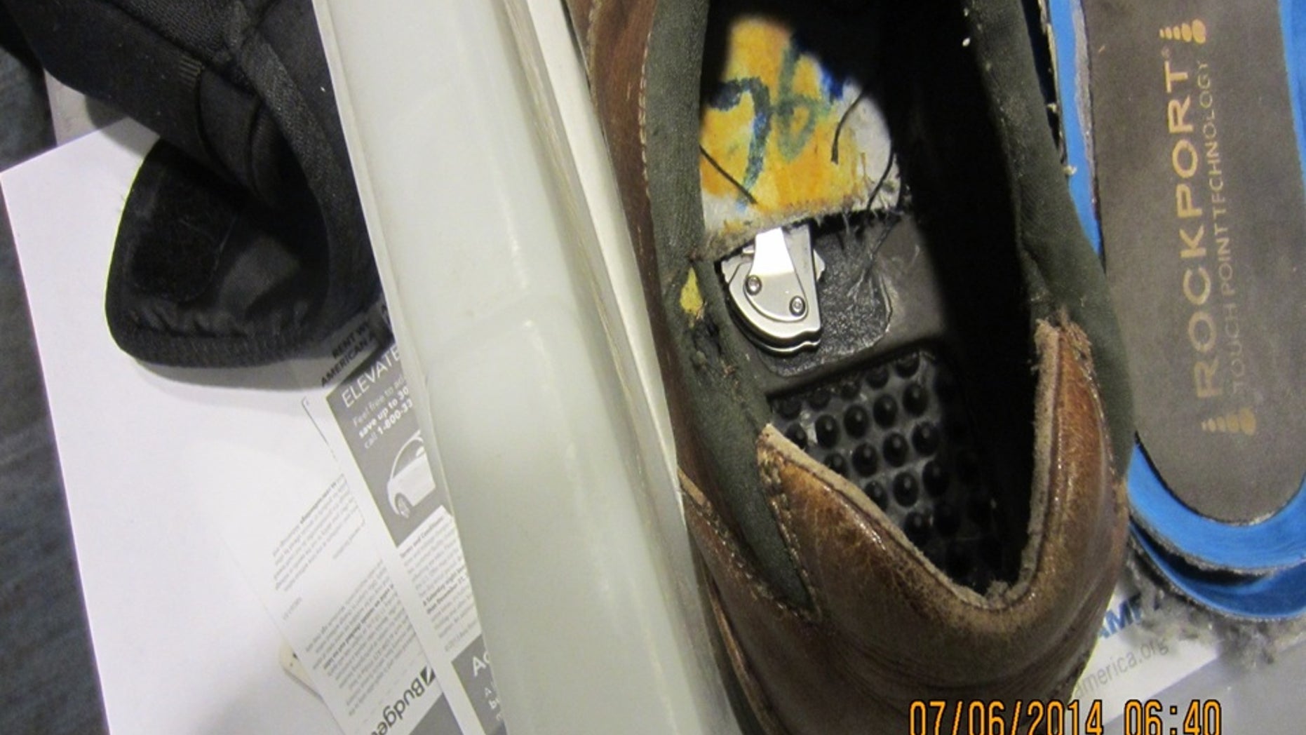 This July 6, 2014 photo provided by the Transportation Security Administration shows a knife concealed inside the bottom lining of a shoe belonging to a passenger at Detroit Metropolitan Airport in Romulus, Mich. The TSA says airport police responded, took possession of the knife and arrested the passenger. (AP Photo/Transportation Security Administration)