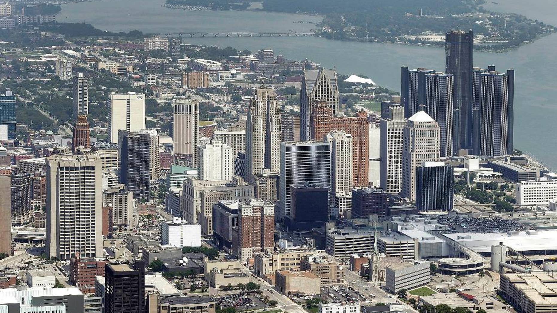 In this July 16, 2013 aerial file photo, the downtown of the city of Detroit is shown. Detroit Emergency Manager Kevyn Orr raised more than a few eyebrows a year ago when he took the city into bankruptcy and predicted it would be out by the time his term expired in fall 2014. Because it is by far the largest city to file for municipal bankruptcy and the issues were so complex many experts predicted it would take years to resolve. But the city will take a major step toward that goal with a trial in federal bankruptcy court that starts Tuesday, Sept 2, 2014. (AP Photo/Paul Sancya, File)