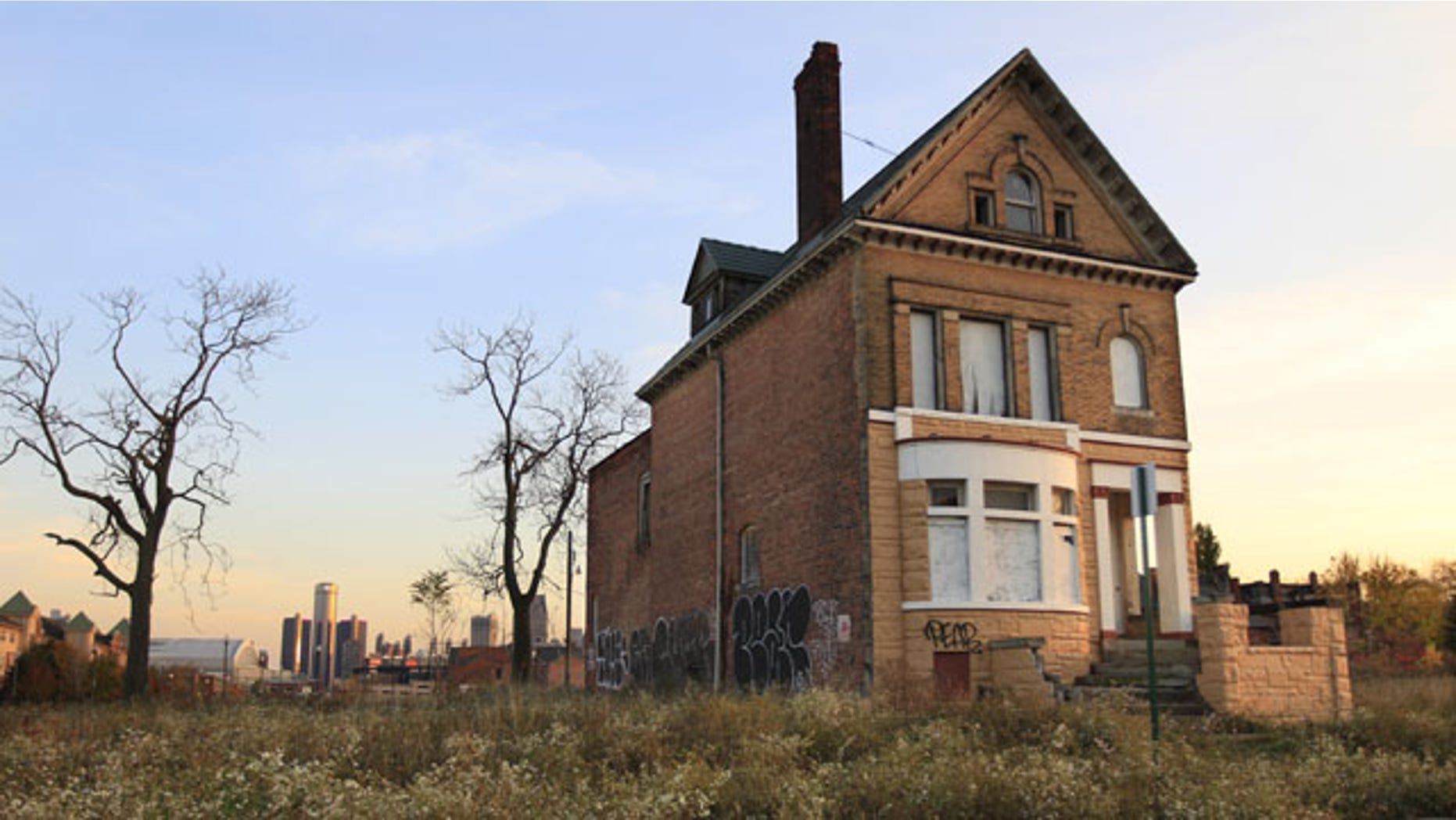 FILE - This Oct. 24, 2012 file photo shows a graffiti-marked abandoned home north of downtown Detroit, in background.(AP Photo)