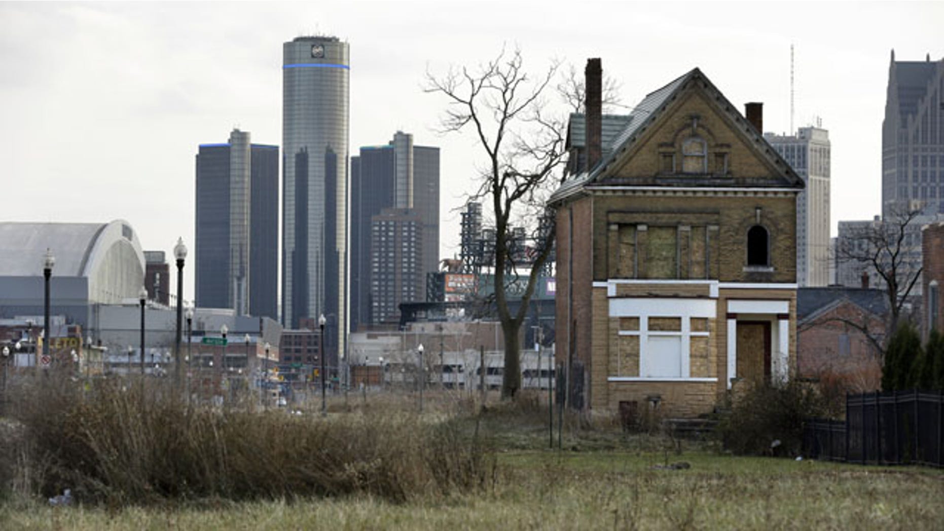 December 2, 2013: An empty field in Brush Park, north of Detroit's downtown, is shown with an abandoned home. (AP Photo)