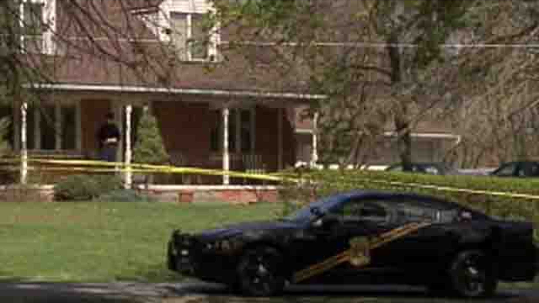 April 4, 2012: Police are seen outside the home where an apparent triple murder-suicide occurred.