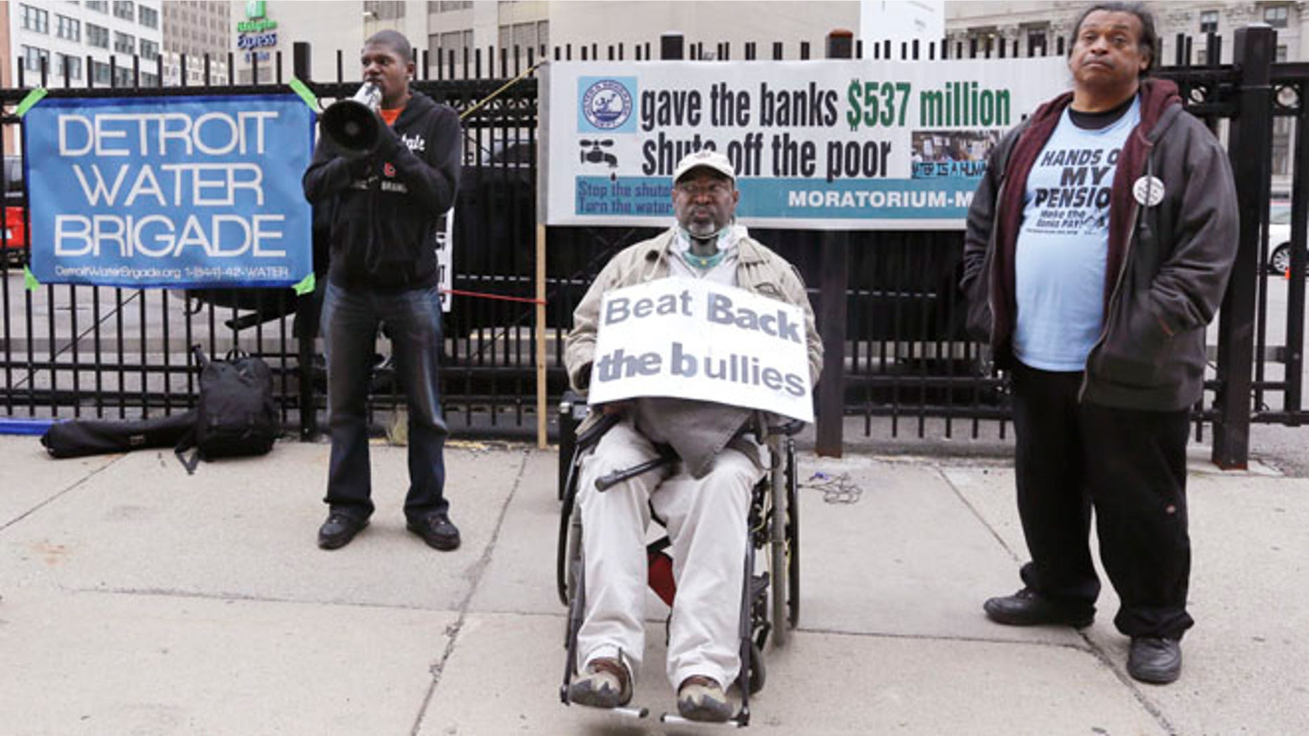 Sept. 22, 2014: Demeeko Williams, left, of the Detroit Water Brigade talks into a megaphone during a rally outside federal courthouse in Detroit. (AP)