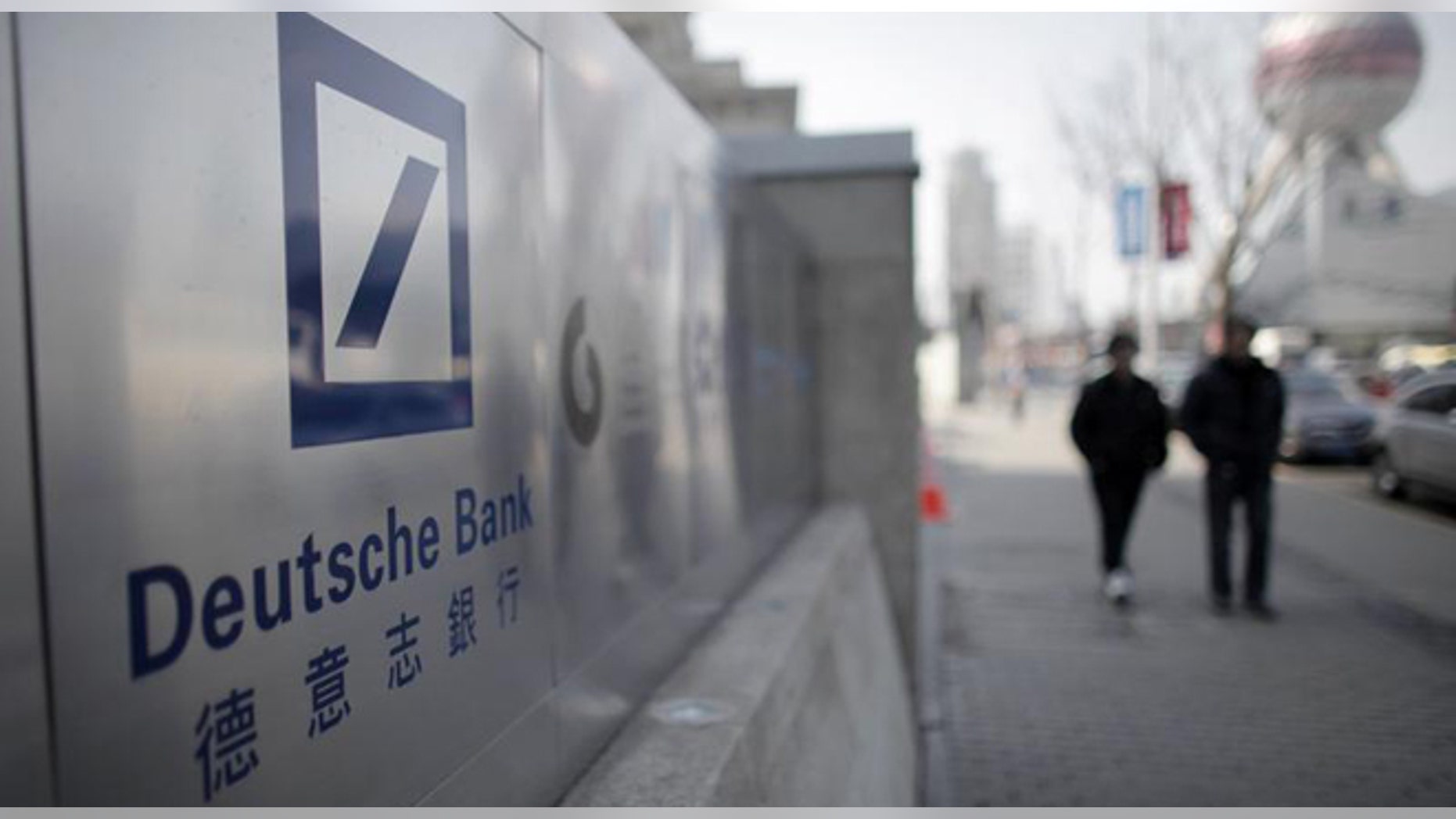 A Deutsche Bank sign is seen outside of a corporate building in Shanghai's financial district February 23, 2011. REUTERS/Carlos Barria