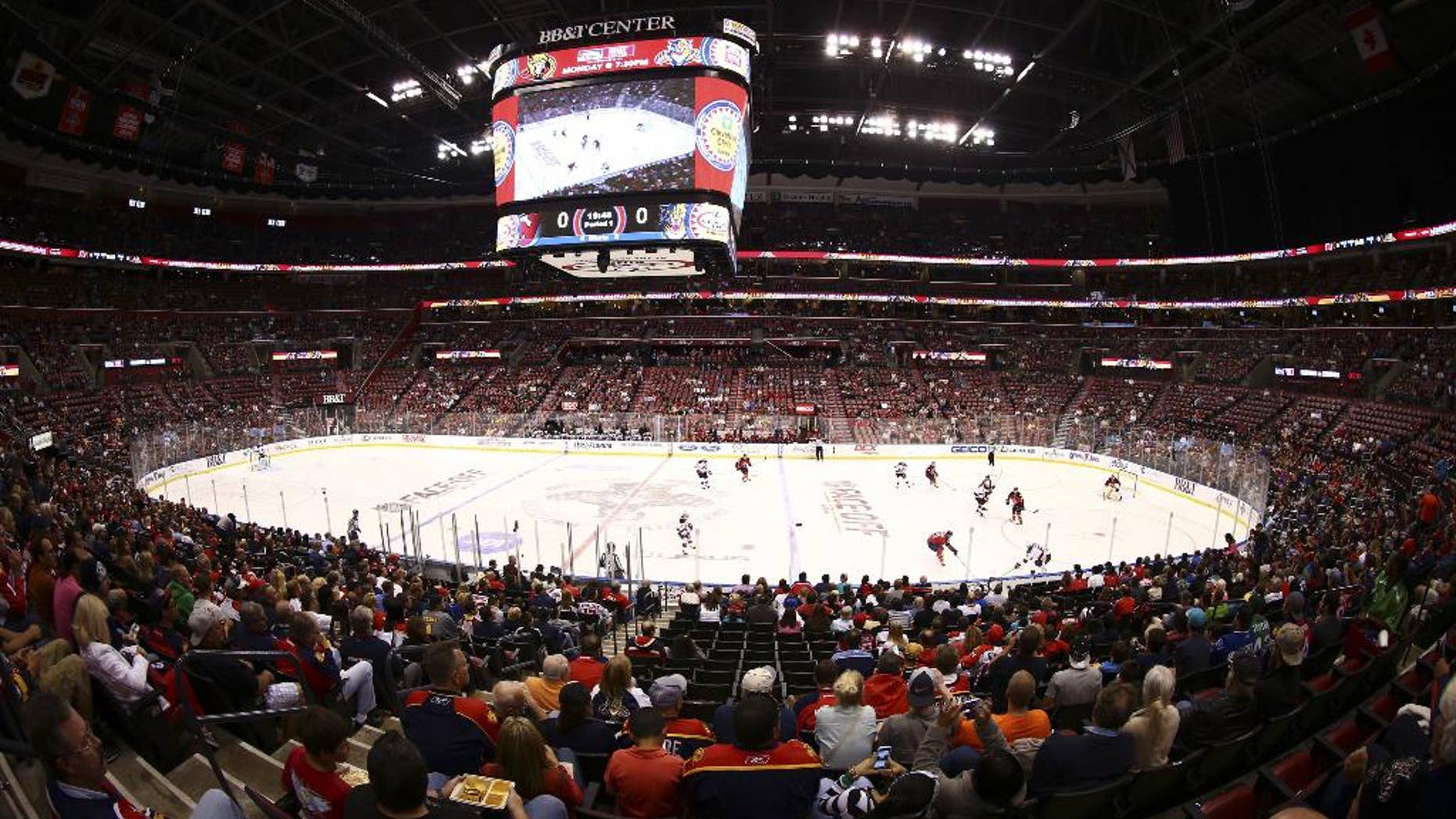 RETRANSMITTING FOR IMPROVED QUALITY In this image made with a fisheye lens, Florida Panthers hockey fans watch game action against the New Jersey Devils during the first period of a NHL hockey game in Sunrise, Fla., Saturday, Oct. 11, 2014. (AP Photo/J Pat Carter)