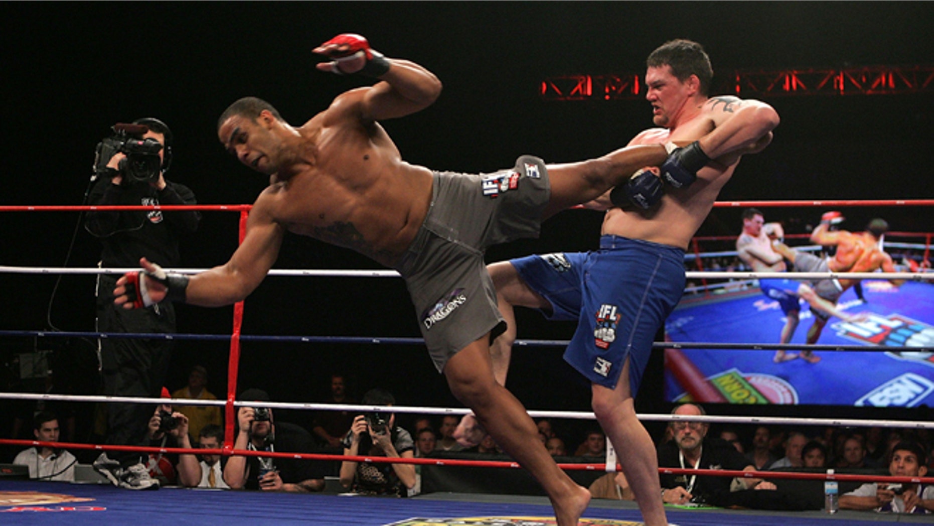 ATLANTA - FEBRUARY 23: Rafael Feijao of Team Dragon (grey trunks) battles Devin Cole (blue trunks) of Team Red Bears during the International Fight League event at The Arena at Gwinnett Center on February 23, 2007 in Atlanta, Georgia. (Photo by Chris Trotman/Getty Images for IFL)