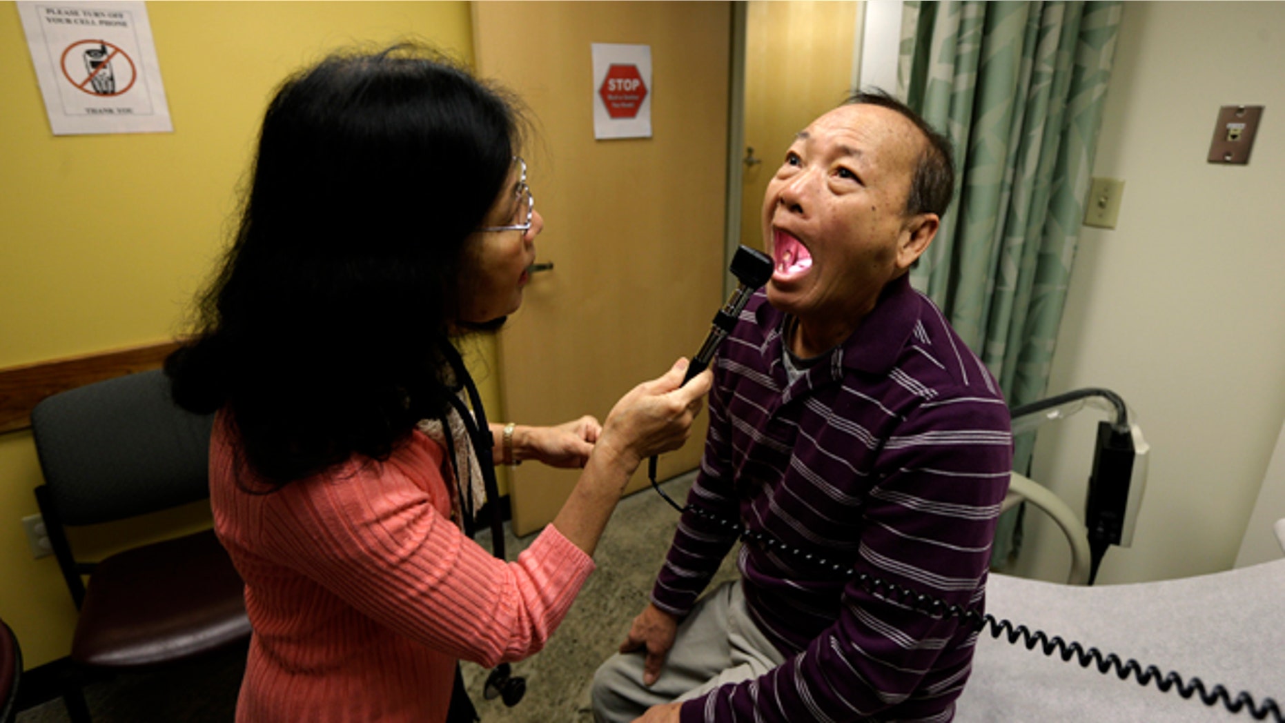 FILE - In this Friday, March 1, 2013 file photo, Chan Lai Ly, right, has his mouth examined by Honghue Duong, a physician's assistant, as part of a regular check-up related to his diabetes at International Community Health Services in Seattle. Over the last two decades, the rates of heart attacks and strokes among diabetics fell by more than 60 percent, a new federal study shows. The research from the Centers for Disease Control and Prevention was reported in the Thursday, April 17, 2014 edition of the New England Journal of Medicine. The drop is mainly attributed to better screening, medicines and care. The improvements came even as the number of U.S. adults with diabetes more than tripled in those 20 years. (AP Photo/Ted S. Warren)