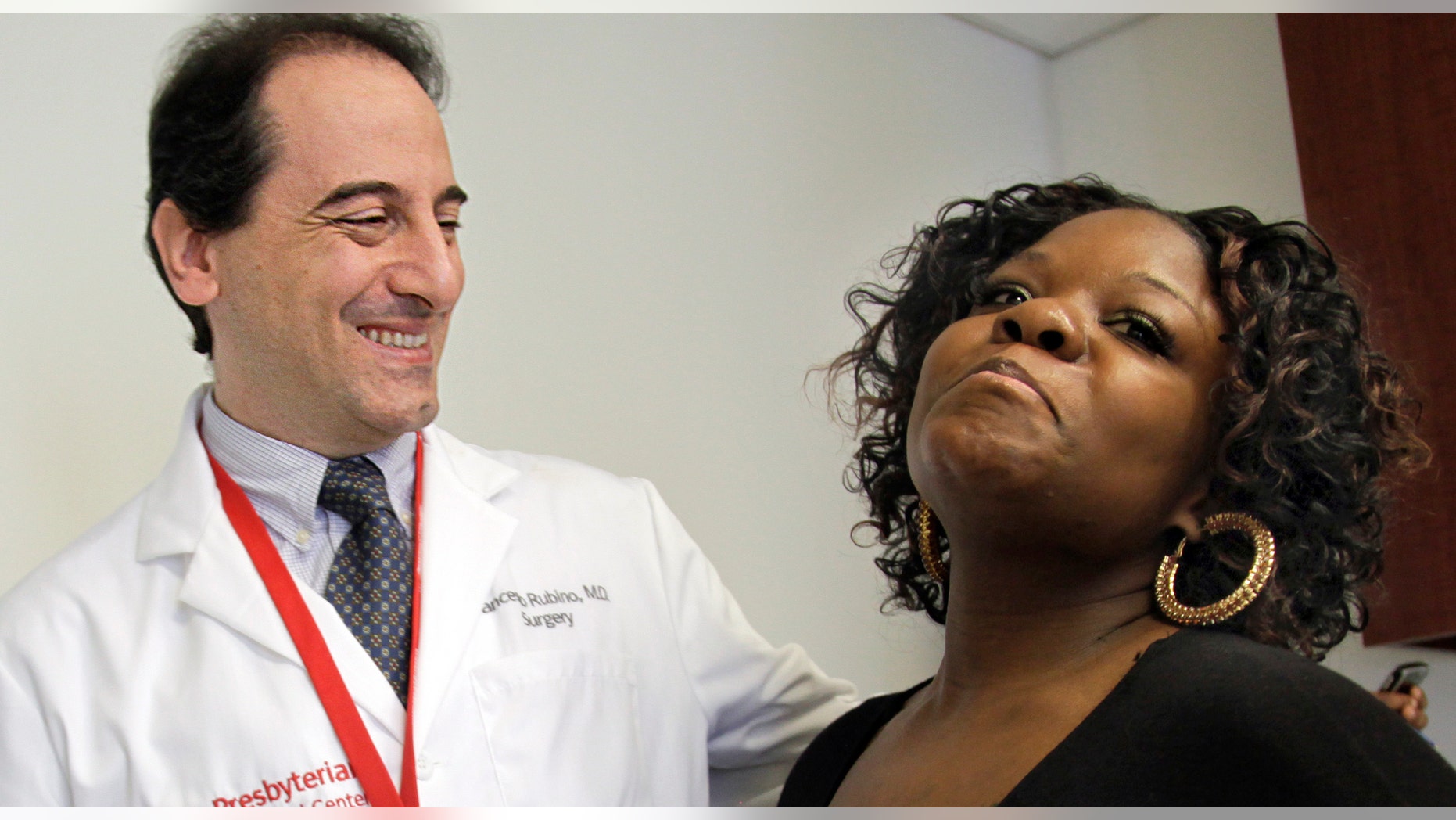 In this March 23, 2012 photo, Dr. Francesco Rubino, a surgeon at Weill Cornell Medical Center, joins his patient Tamikka McCray, 39, for an interview in New York. McCray no longer needed to take diabetes medication and insulin after her weigh-loss surgery. Research by Dr. Francesco Rubino, McCray's surgeon at Weill Cornell, and other doctors gives clear proof that weight-loss surgery can reverse and possibly cure diabetes. (AP Photo/Bebeto Matthews)
