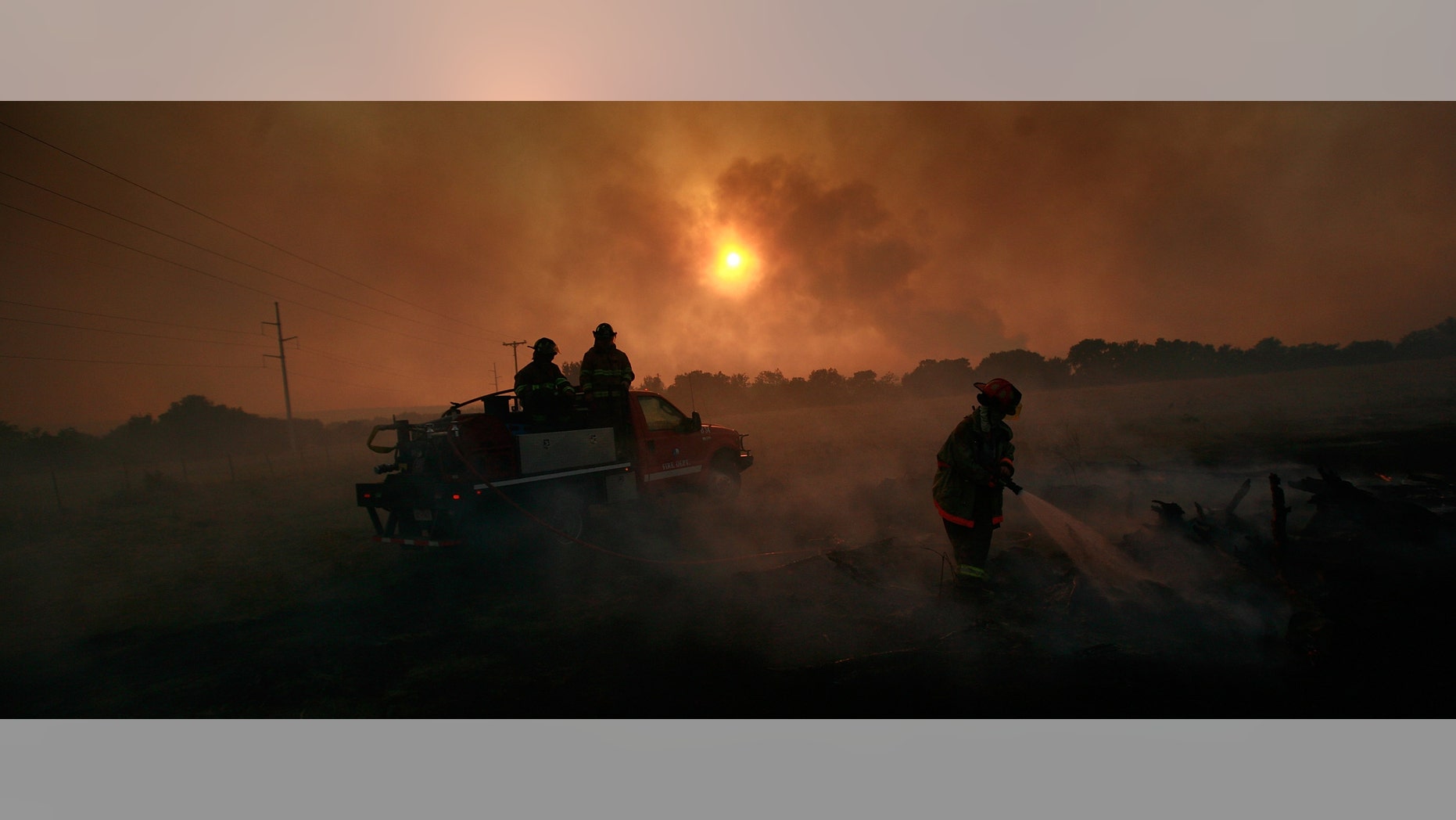 GRAFORD, TX - APRIL 19: Volunteer firefighters battle a running wildfire on April 19, 2011 in Graford, Texas. Dozens of area homes have been destroyed in the wildfires that have been fueled by dry conditions, high winds, and low humidity. (Photo by Tom Pennington/Getty Images)