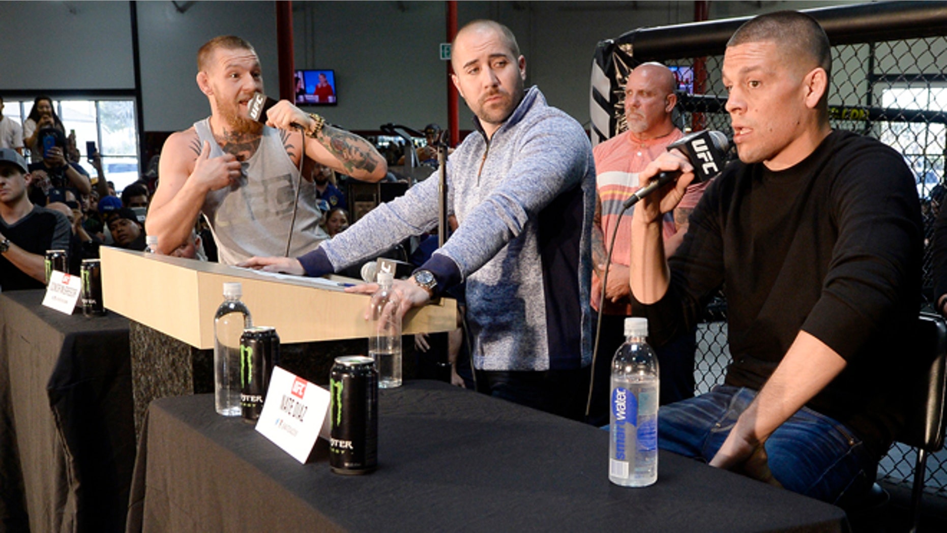 TORRANCE, CA - FEBRUARY 24: UFC featherweight champion Conor McGregor (L) and lightweight contender Nate Diaz (R) participate in a news conference with moderator Dave Sholler (C), UFC vice president of public relations, at UFC Gym February 24, 2016, in Torrance, California. (Photo by Kevork Djansezian/Getty Images)