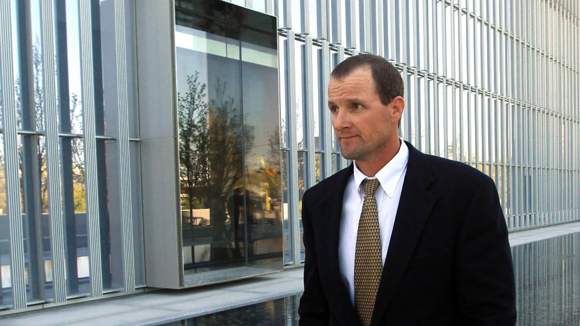 Jared Ehlers, of Moab, walks from the Federal Courthouse after appearing in court Wednesday, April 30, 2014, in Salt Lake City. Ehlers has has pleaded not guilty to federal charges of stealing a fossilized dinosaur footprint. He is accused of dislodging a piece of sandstone with a three-toed ancient dinosaur track from the Hell's Revenge jeep Trail in the Sand Flats Recreation Area near Moab. Ehlers is charged under a federal law passed in 2009 to protect paleontological artifacts. (AP Photo/Rick Bowmer)