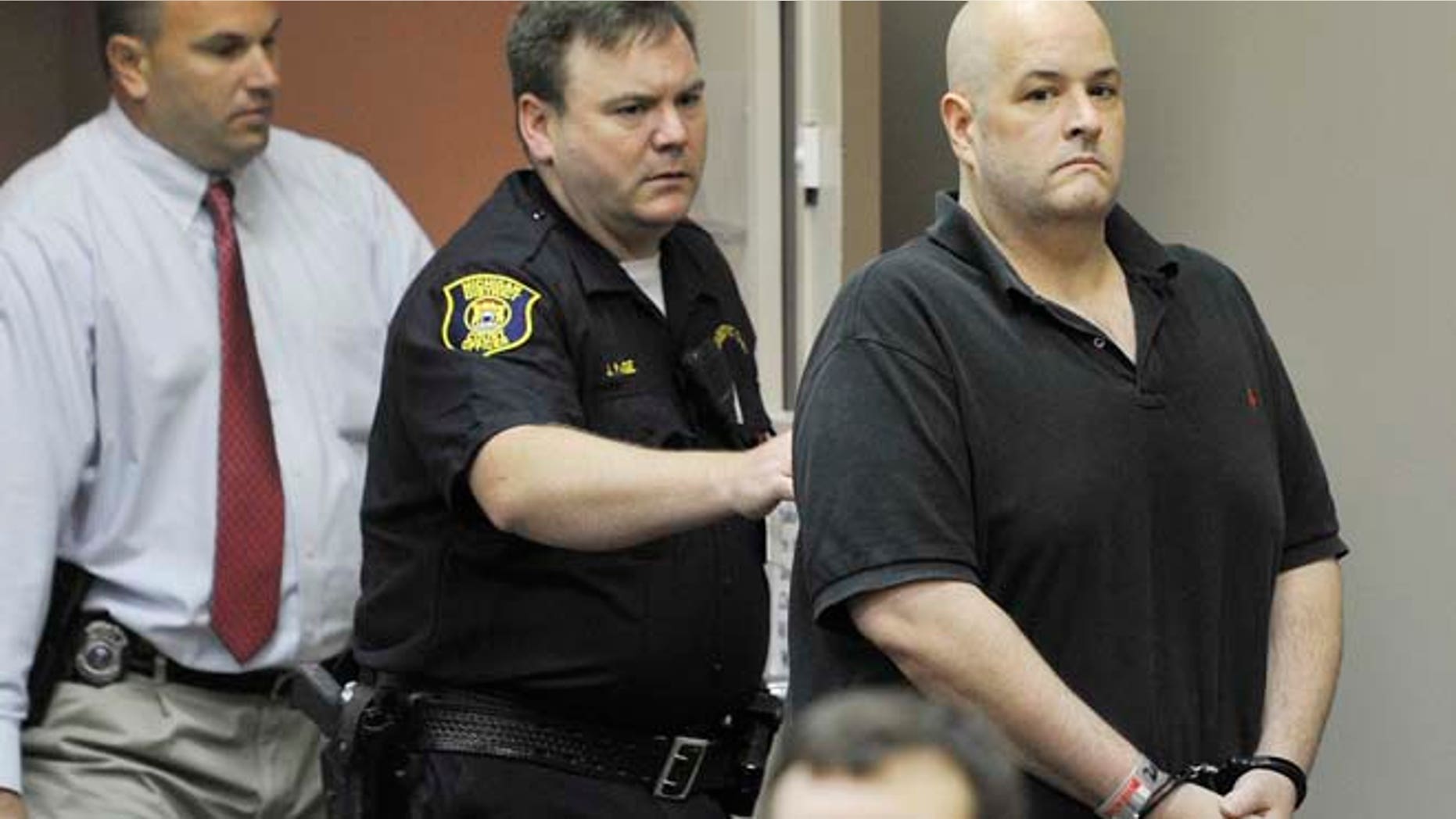 Aug. 20, 2012: In this file photo, Roger Bowling, right, is escorted into a courtroom by police and detectives for a preliminary examination at the 24th District Court in Allen Park, Mich. (AP/The Detroit News)