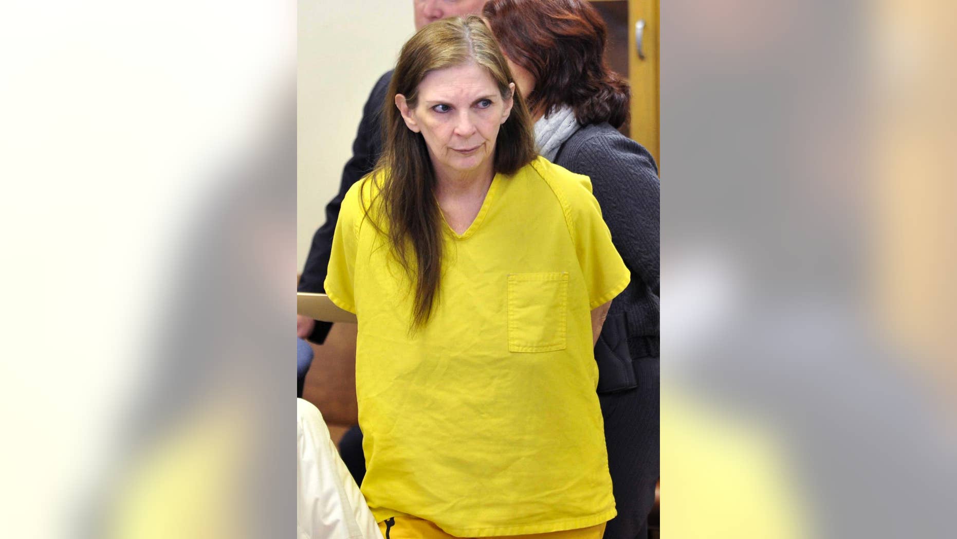 FILE - In this Feb. 3, 2014, file photo, defendant Donna Scrivo looks towards the courtroom at her arraignment in St. Clair Shores, Mich. Scrivo, convicted of killing and dismembering her adult son, faces sentencing, and is due in Macomb County Circuit Court in Mount Clemens on Tuesday, June 30, 2015. First-degree murder carries a mandatory penalty of life in prison without possibility of parole. (Robin Buckson/Detroit News via AP, File)