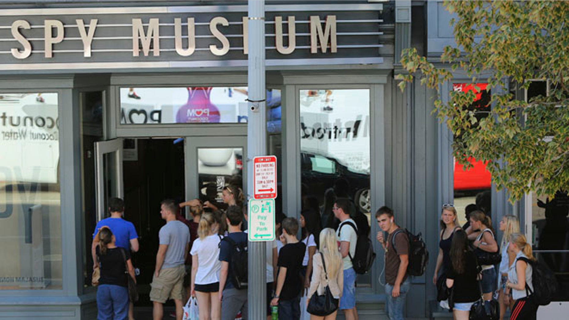 FILE: Oct. 2, 2013: Tourists outside the International Spy Museum, which is open for business and not U.S. government-affiliated, in Washington, D.C.