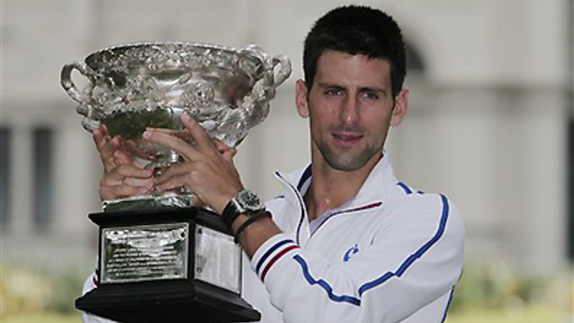 Jan. 30, 2012: Australian Open men's singles champion Serbia's Novak Djokovic poses with his trophy at a park in central Melbourne, Australia. Djokovic defeated Spain's Rafael Nadal in five hours and 53 minutes to win a third Australian Open title earlier in the day.