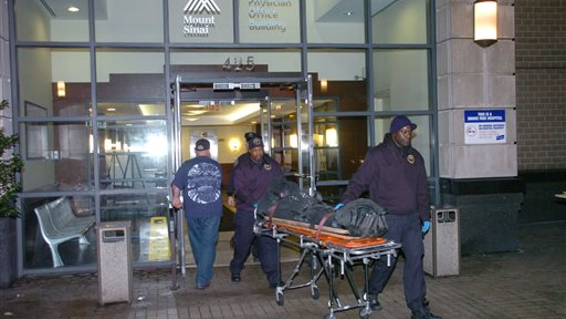 The body of Dmitriy Kanarikov, 35, is removed from 425 west 59th street, Sunday, Dec. 22, 2013, in New York.