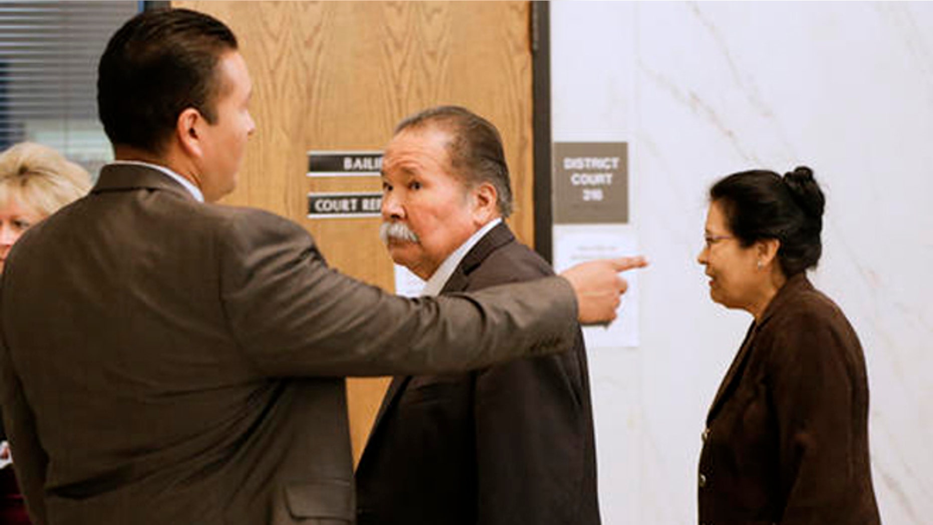 Frederick and Estella Garcia, along with their son Fernando, left, arrive to the Douglas County Courtroom in Omaha, Neb., Monday, Oct. 3, 2016, as lawyers gave opening statements in the first-degree murder trial of their son Anthony Garcia, charged in the killings of four people with ties to Creighton University's medical school. (AP Photo/Nati Harnik)