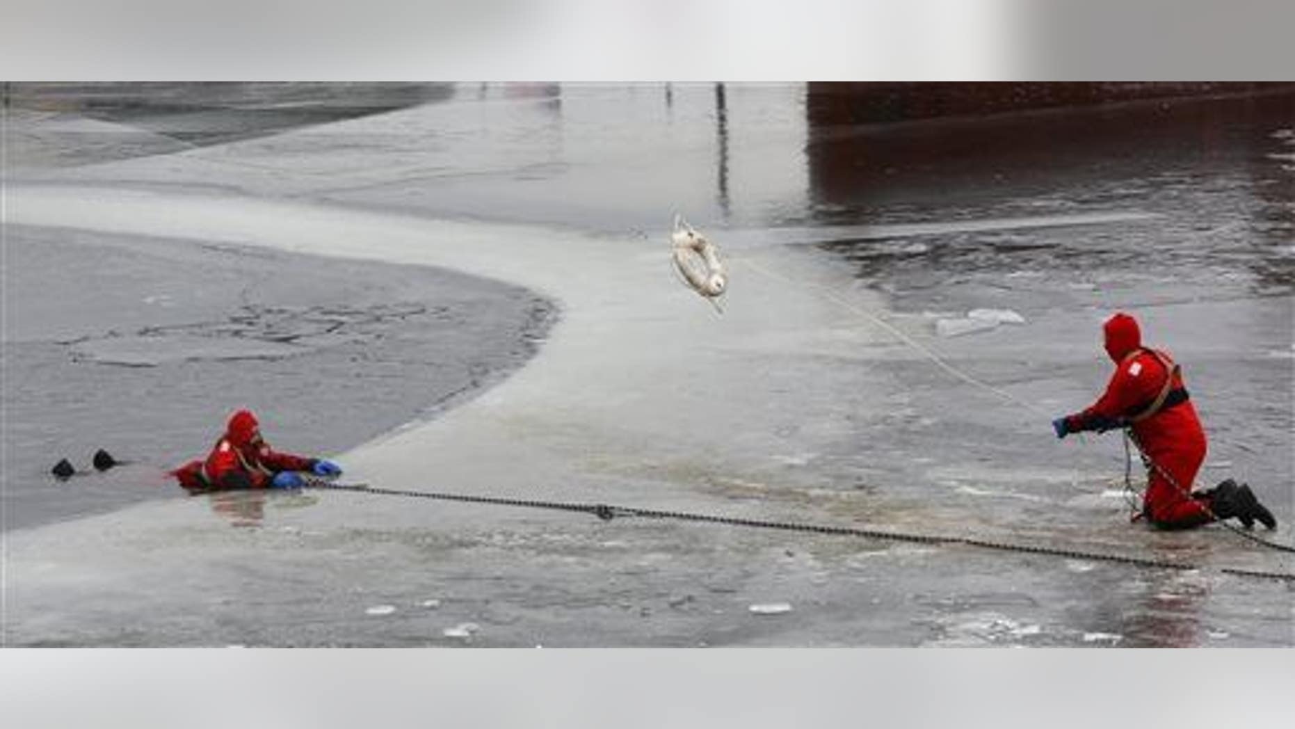 Members of the Dubuque Fire Department perform an ice-rescue training on Thursday, Dec. 4, 2014, in Dubuque, Iowa.