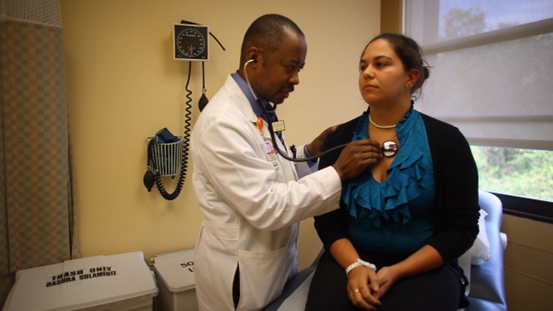 Dr. Gregory Coleman speaks with Vanessa Moreno as she visits him for a check-up in Miami, Florida.