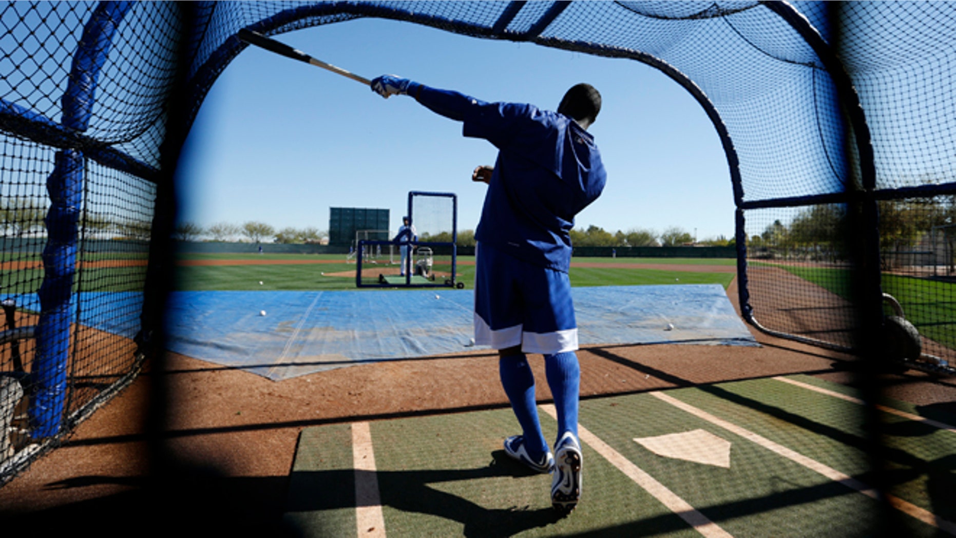 Los Angeles Dodgers' Yasiel Puig points out his shot after hitting a ball during a spring training baseball workout Wednesday, Feb. 25, 2015, in Phoenix. (AP Photo/John Locher)