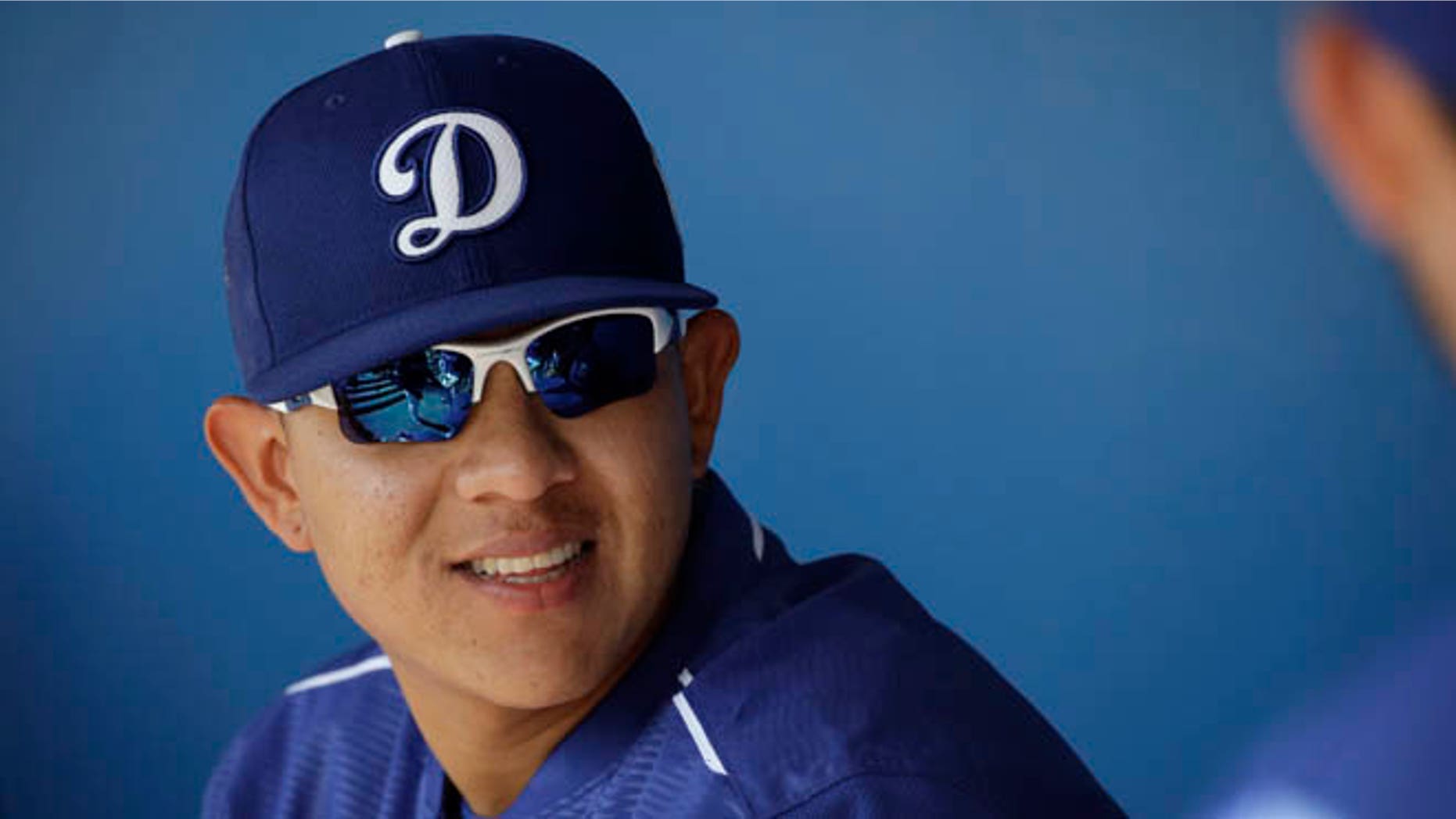 FILE - In this March 14, 2016, Los Angeles Dodgers pitcher Julio Urias smiles while talking to teammates in the dugout during a spring training baseball game against the Milwaukee Urias, 19, is set to make his highly anticipated major league debut for the Dodgers on Friday night, May 27, 2016, in New York against the Mets (AP Photo/Jae C. Hong, File)