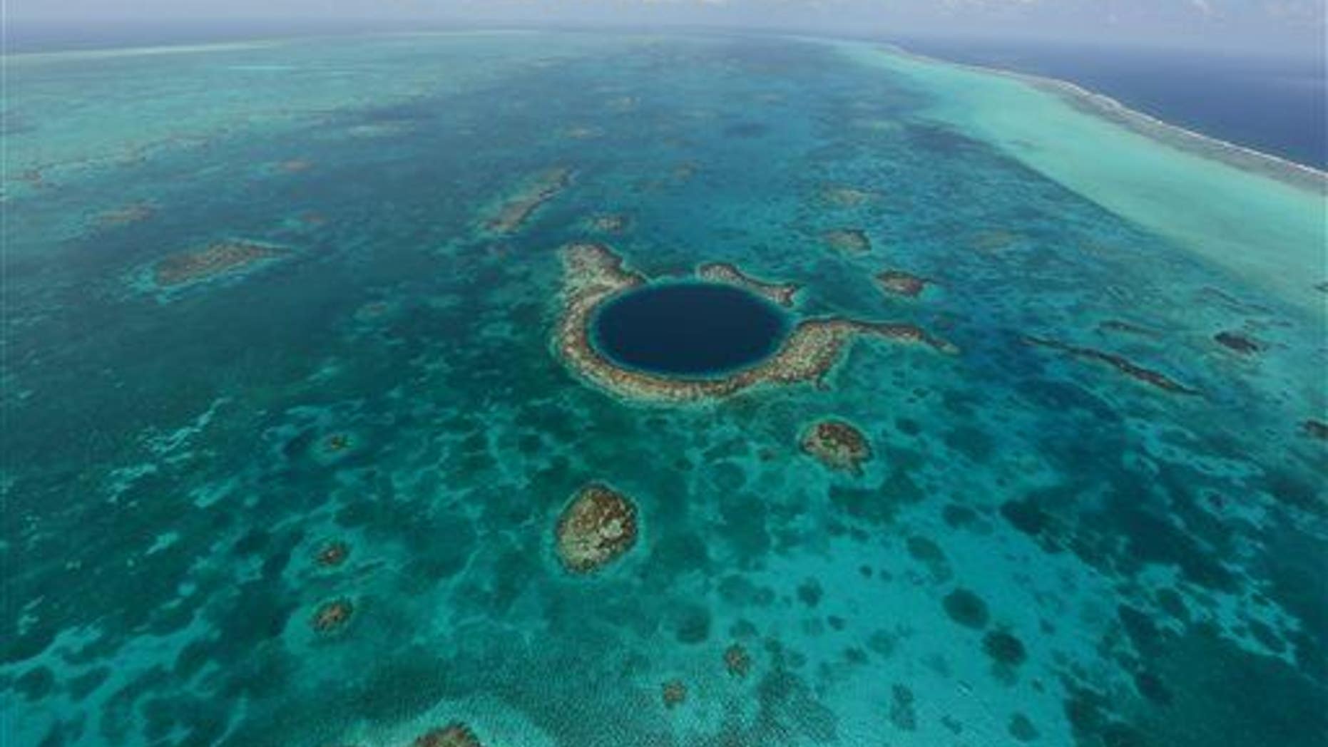 This undated image provided by the Belize Tourist Board shows an aerial view of the Great Blue Hole, a popular diving site that's part of Belize���s barrier reef.