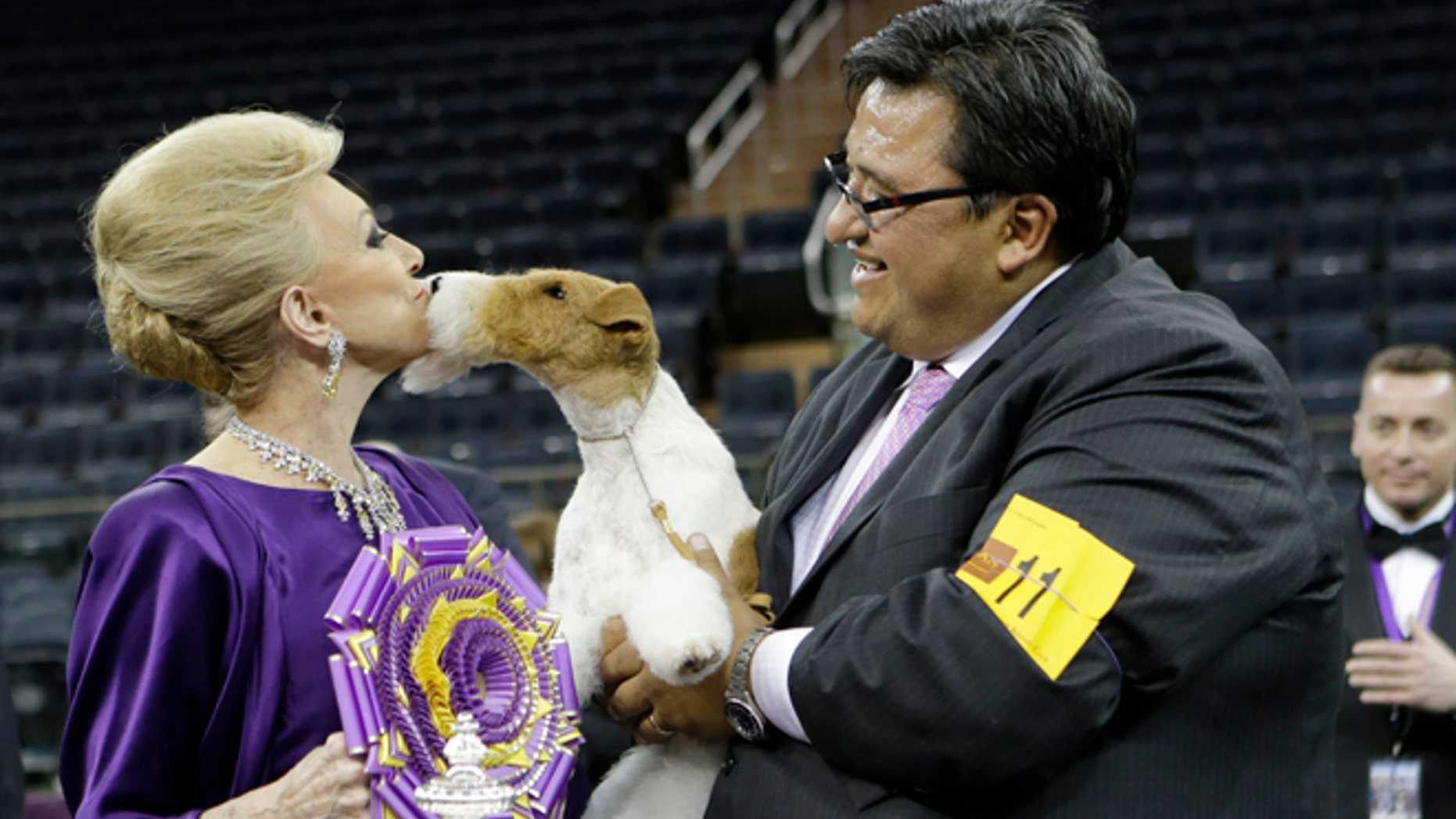 Judge Betty Regina Leininger, left, and handler Gabriel Rangel, pose with Sky, a wire fox terrier, after winning best in show at the Westminster Kennel Club dog show, Tuesday, Feb. 11, 2014, in New York. (AP Photo/Frank Franklin II)