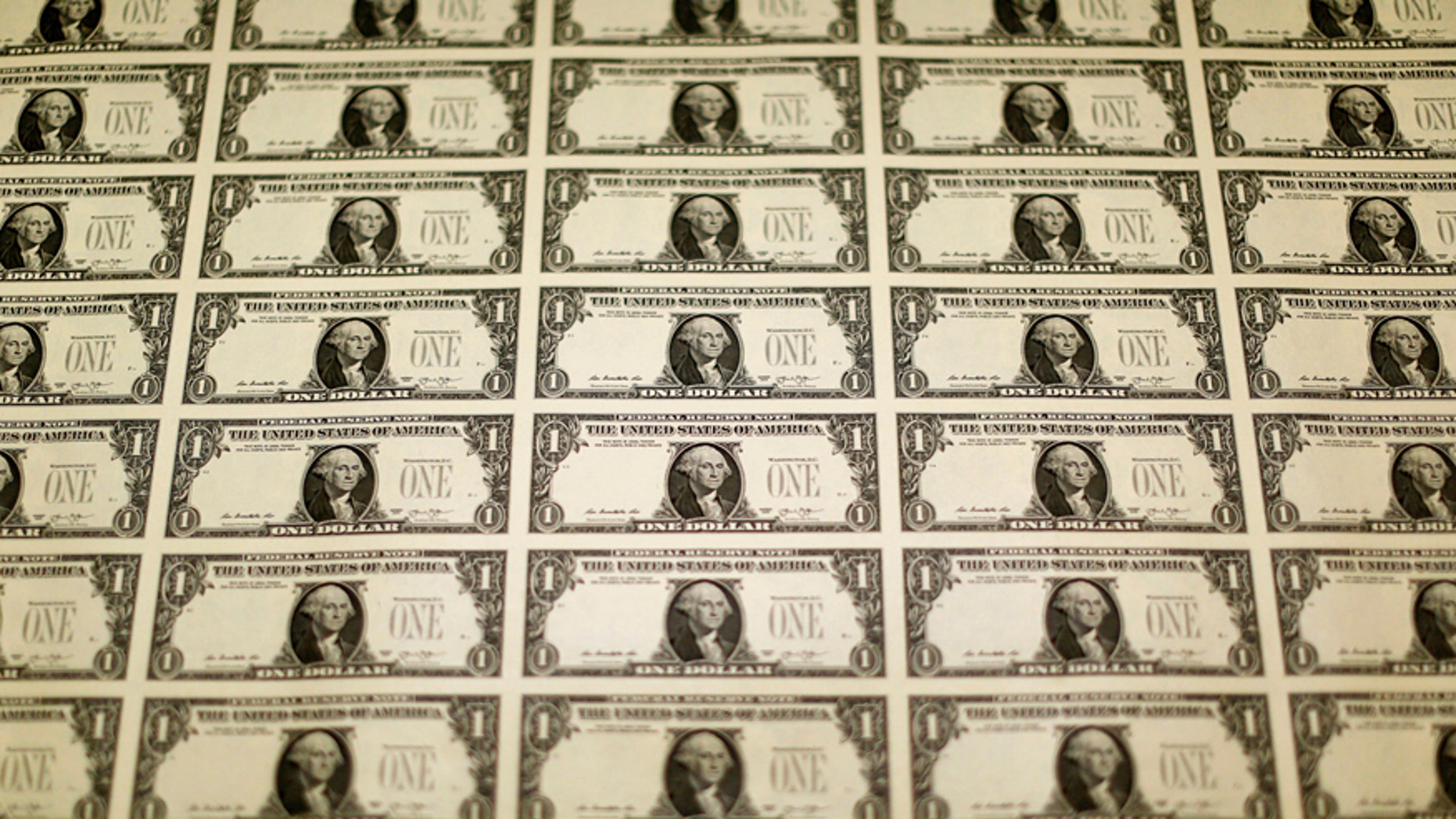 A sheet of the front side of United States one dollar bills is seen during production at the Bureau of Engraving and Printing in Washington November 14, 2014.