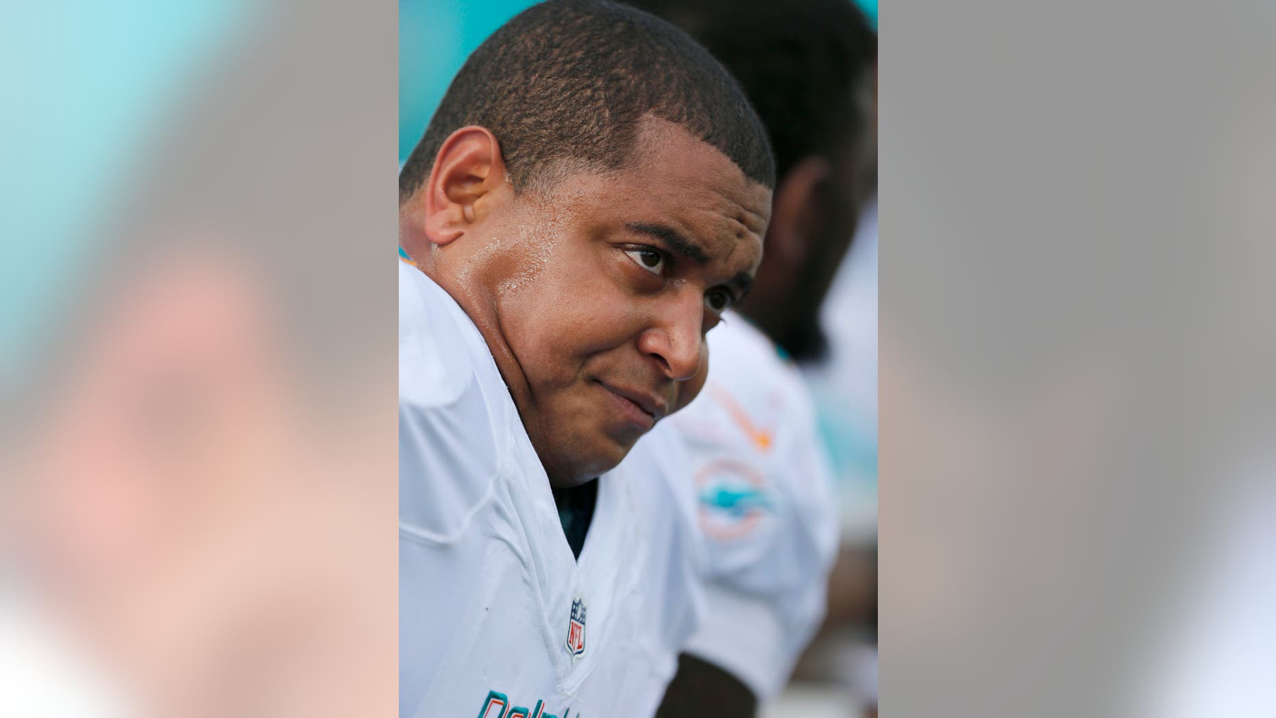 Oct. 27, 2013: In this file photo, Miami Dolphins tackle Jonathan Martin sits on the bench in the first quarter of an NFL football game against the New England Patriots, in Foxborough, Mass.